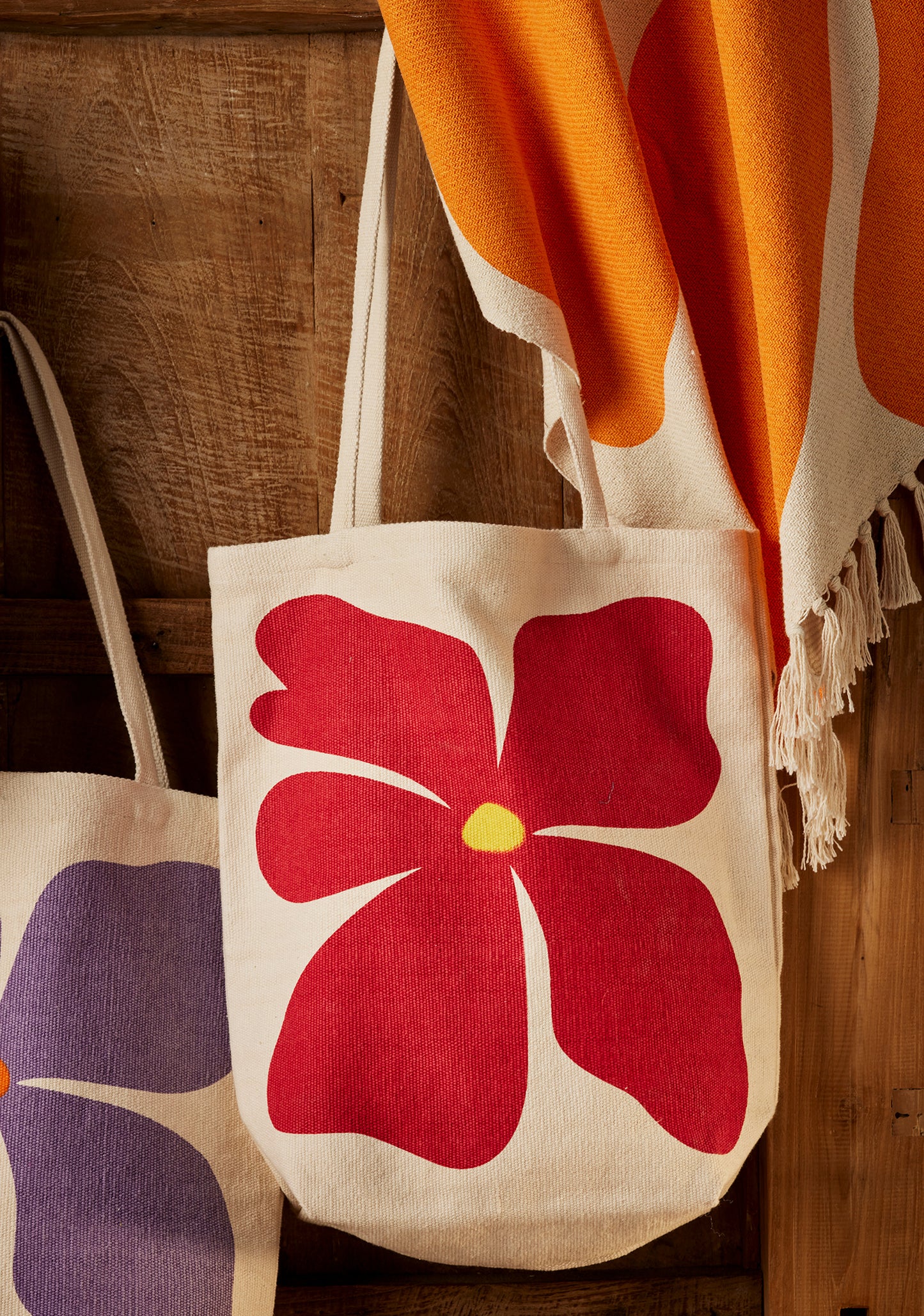 Bright joyful recycled cotton bags with bold flower prints. Long handles. Thick strong cotton.