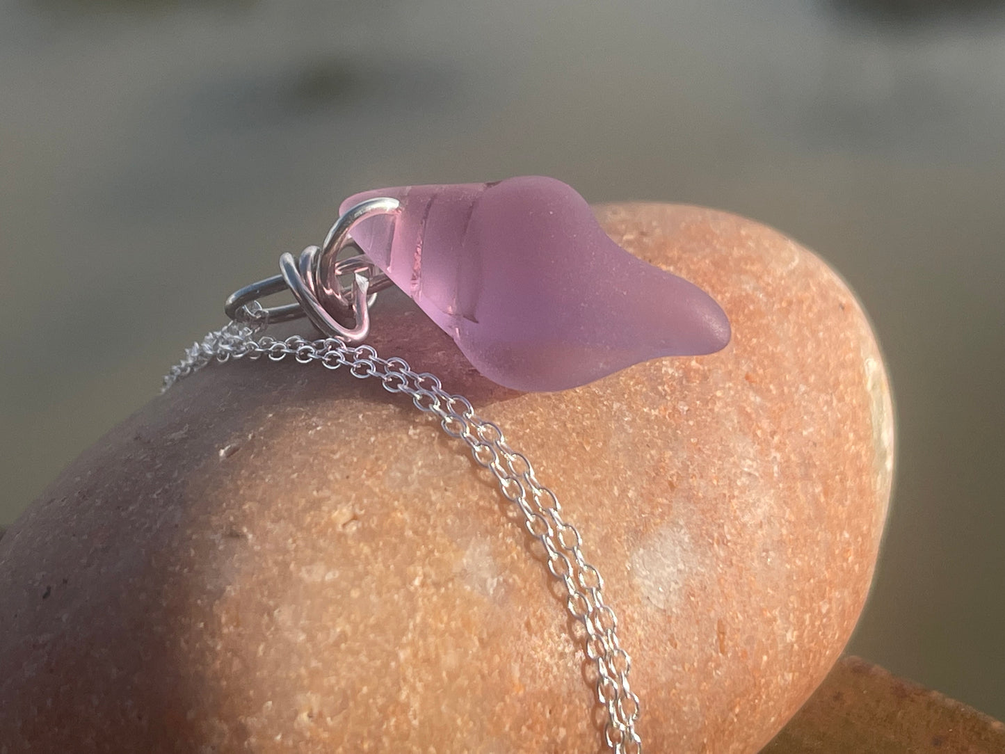 Eco friendly glass necklace on a sterling silver chain showcasing a pink shell pendant. Eco friendly jewellery. Ethical handmade jewellery