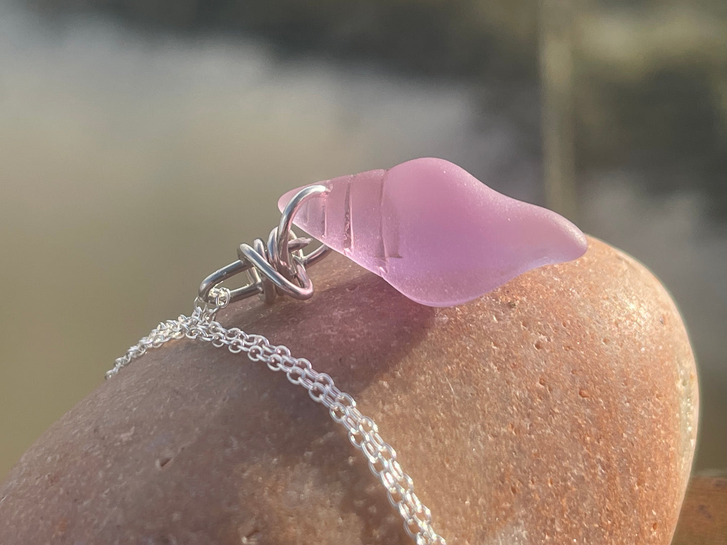 Eco friendly glass necklace on a sterling silver chain showcasing a pink shell pendant. Eco friendly jewellery. Ethical handmade jewellery