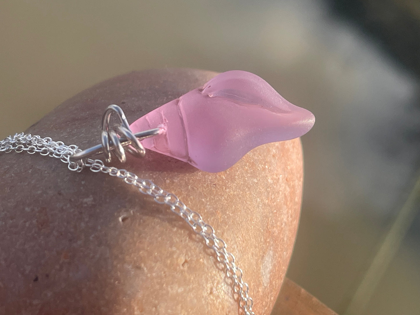 Eco friendly glass necklace on a sterling silver chain showcasing a pink shell pendant. Eco friendly jewellery. Ethical handmade jewellery