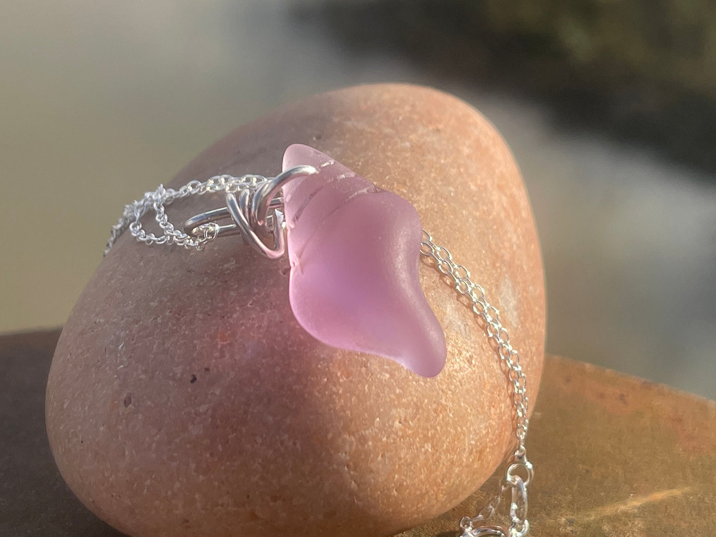 Eco friendly glass necklace on a sterling silver chain showcasing a pink shell pendant. Eco friendly jewellery. Ethical handmade jewellery