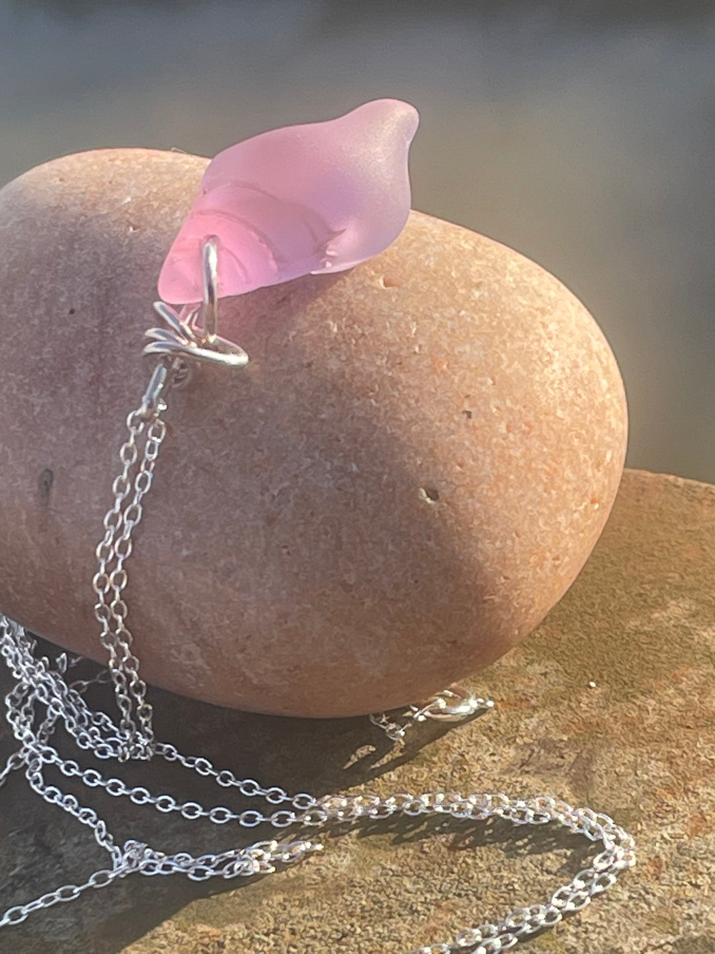 Eco friendly glass necklace on a sterling silver chain showcasing a pink shell pendant. Eco friendly jewellery. Ethical handmade jewellery
