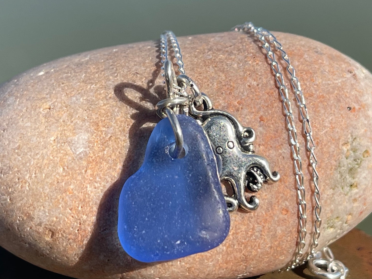 Eco friendly sea glass necklace on a sterling silver chain showcasing a little octopus. Octopus pendant, octopus necklace, ethical jewellery