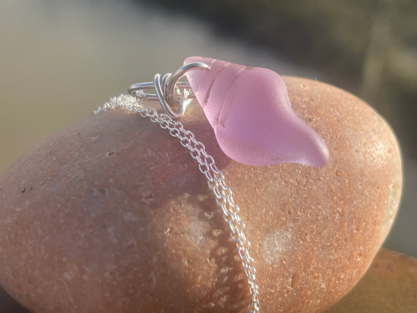 Eco friendly glass necklace on a sterling silver chain showcasing a pink shell pendant. Eco friendly jewellery. Ethical handmade jewellery