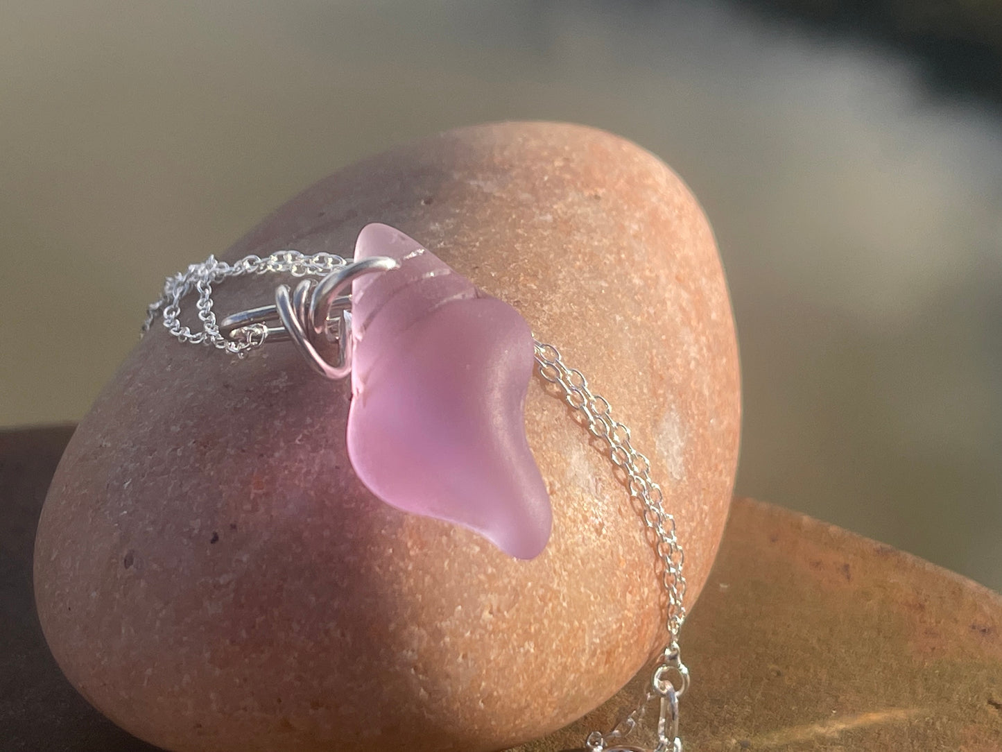 Eco friendly glass necklace on a sterling silver chain showcasing a pink shell pendant. Eco friendly jewellery. Ethical handmade jewellery