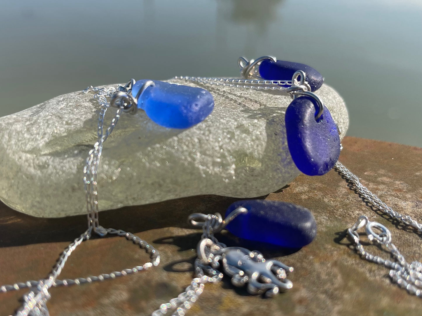 Eco friendly sea glass necklace on a sterling silver chain showcasing a little octopus. Octopus pendant, octopus necklace, ethical jewellery