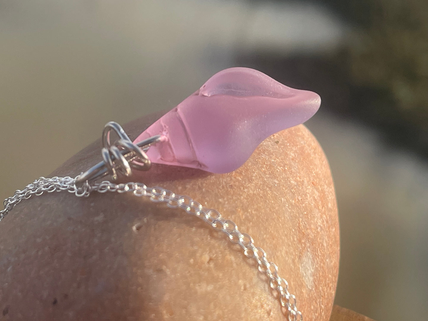 Eco friendly glass necklace on a sterling silver chain showcasing a pink shell pendant. Eco friendly jewellery. Ethical handmade jewellery