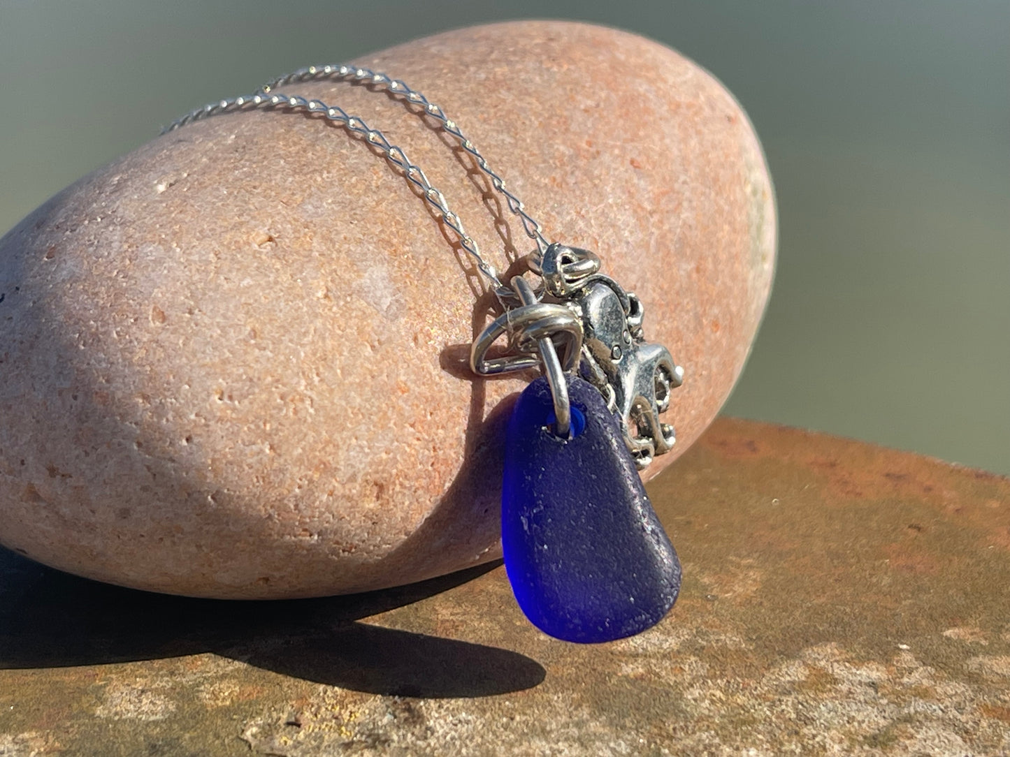 Eco friendly sea glass necklace on a sterling silver chain showcasing a little octopus. Octopus pendant, octopus necklace, ethical jewellery