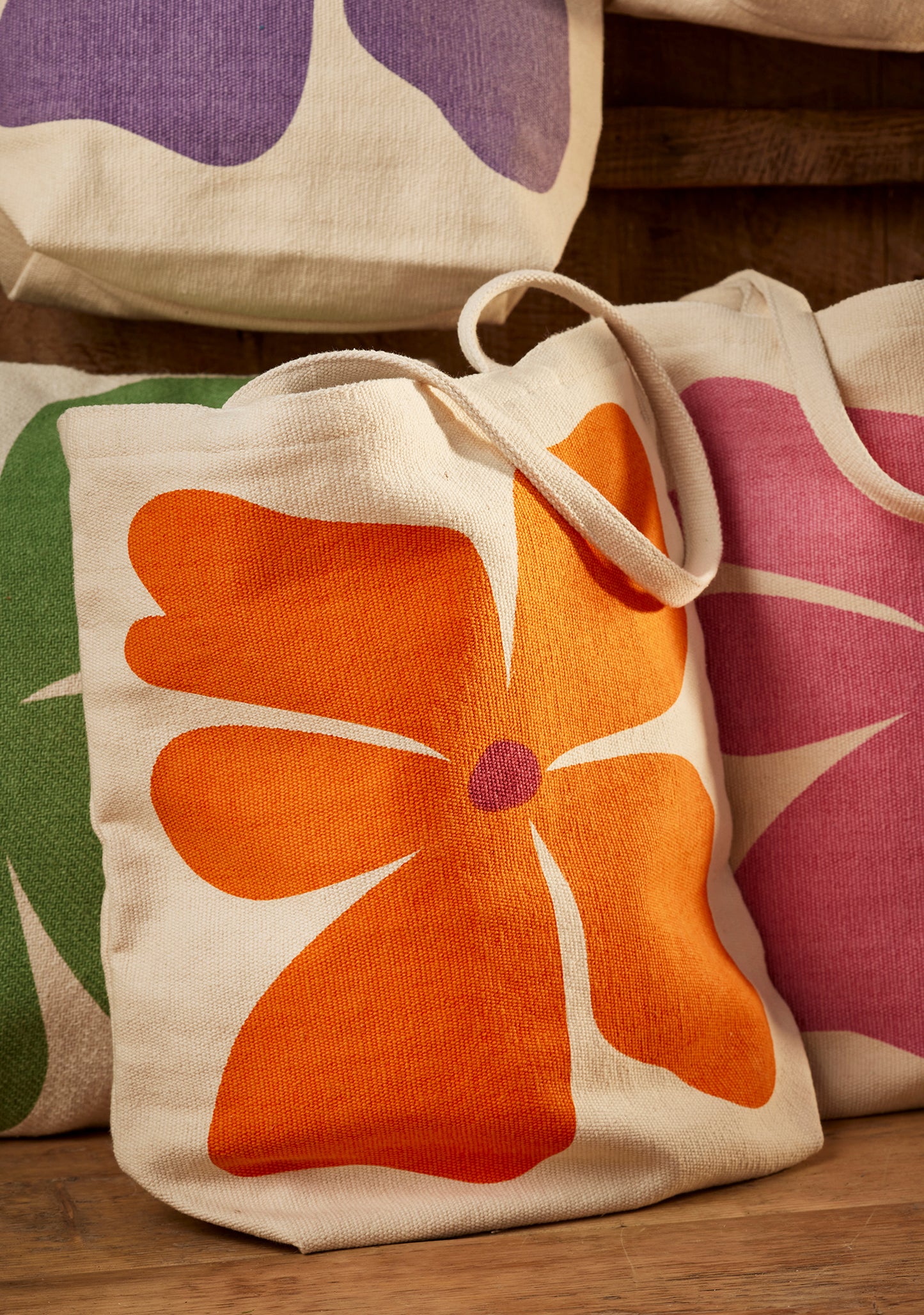 Bright joyful recycled cotton bags with bold flower prints. Long handles. Thick strong cotton.