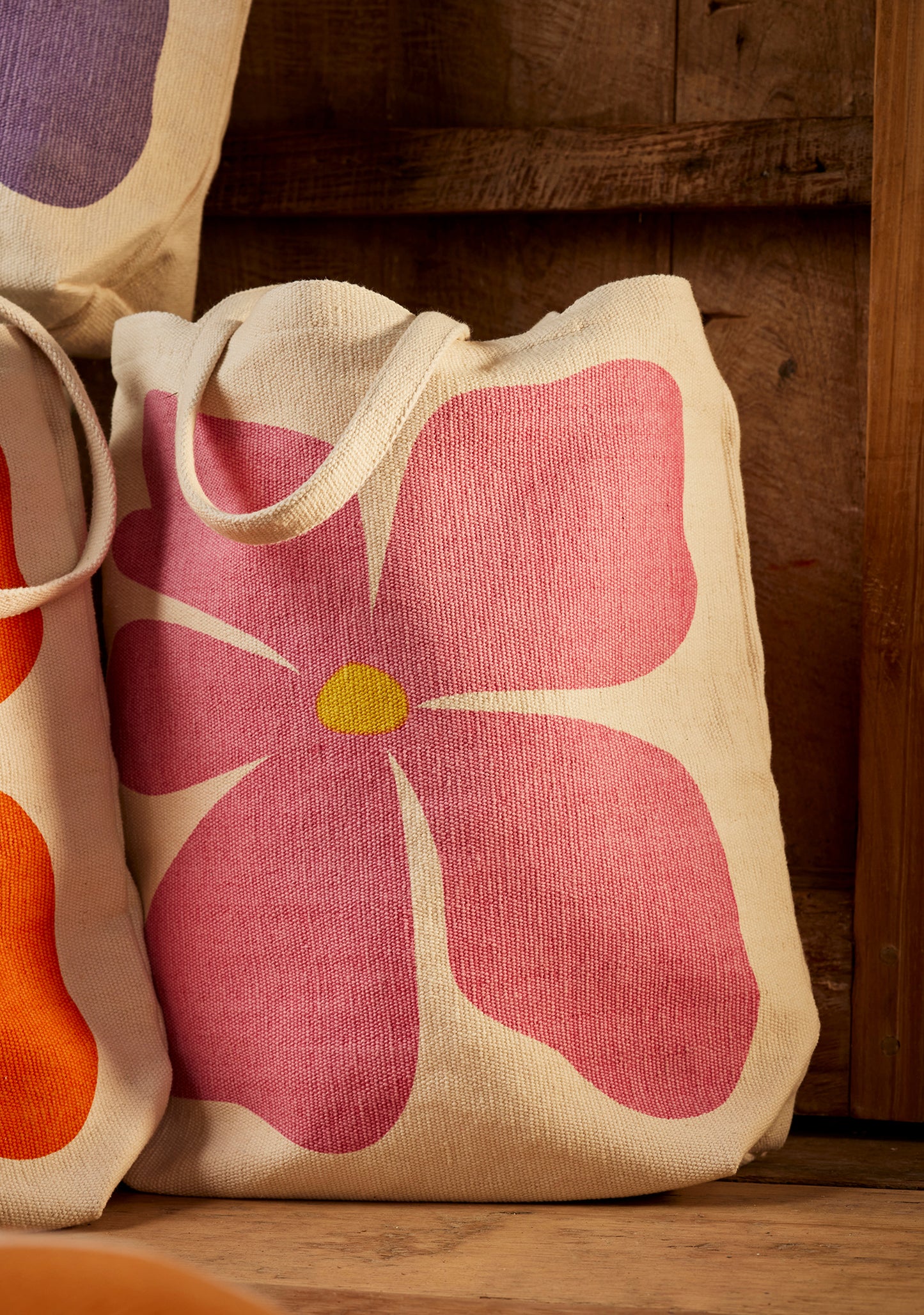 Bright joyful recycled cotton bags with bold flower prints. Long handles. Thick strong cotton.