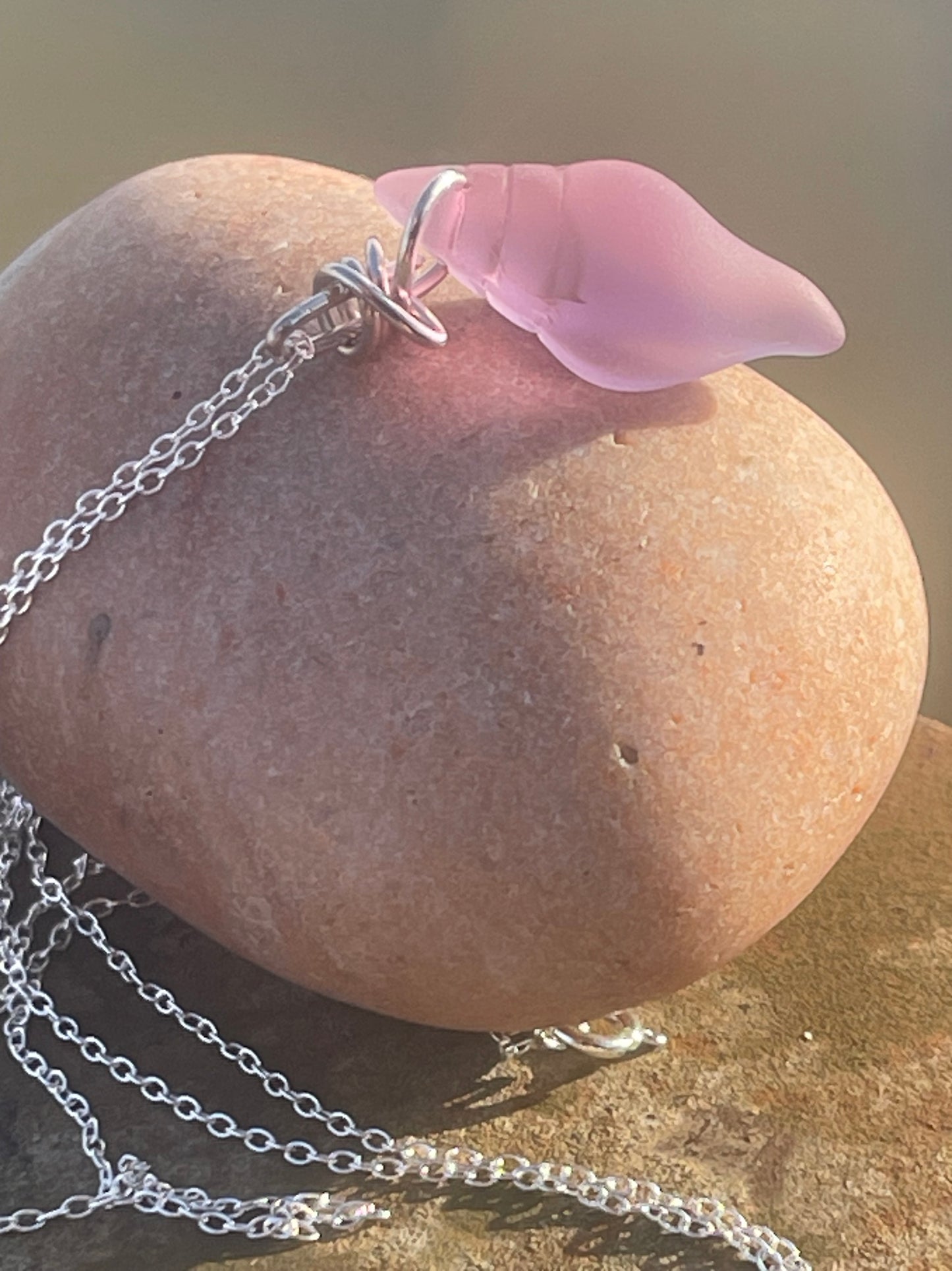Eco friendly glass necklace on a sterling silver chain showcasing a pink shell pendant. Eco friendly jewellery. Ethical handmade jewellery