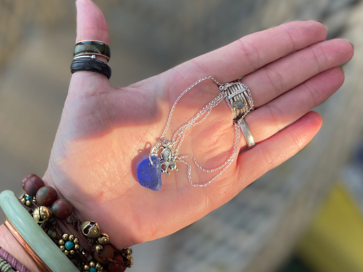 Eco friendly sea glass necklace on a sterling silver chain showcasing a little octopus. Octopus pendant, octopus necklace, ethical jewellery