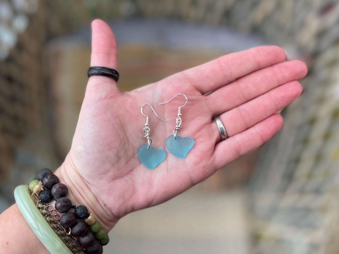 Sea glass heart earrings iron recycled sterling silver. Eco conscious jewellery. Ethical jewellery. Blue sea glass hearts. Handmade earrings