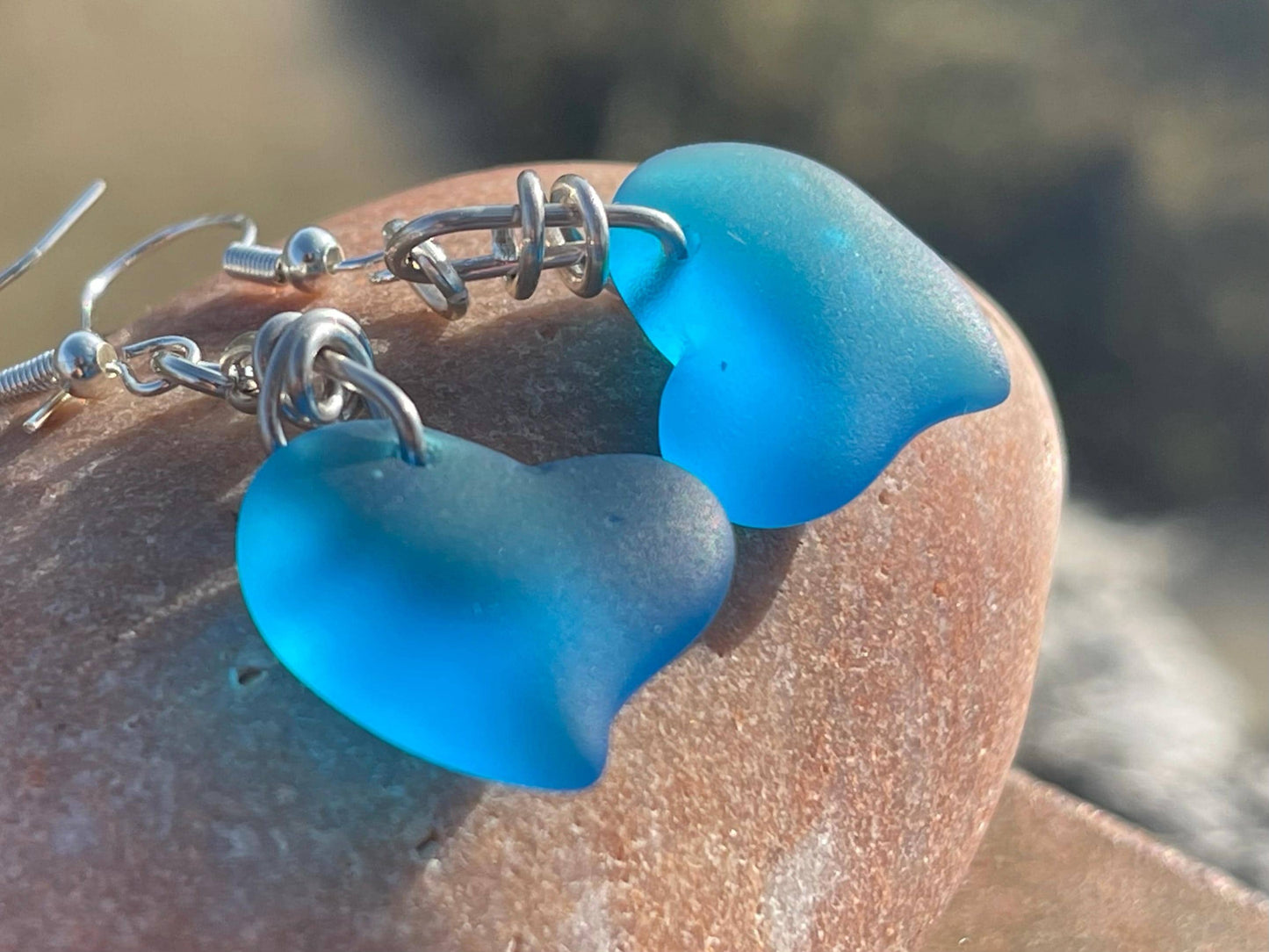 Sea glass heart earrings iron recycled sterling silver. Eco conscious jewellery. Ethical jewellery. Blue sea glass hearts. Handmade earrings
