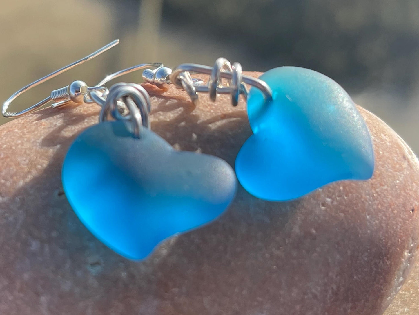 Sea glass heart earrings iron recycled sterling silver. Eco conscious jewellery. Ethical jewellery. Blue sea glass hearts. Handmade earrings