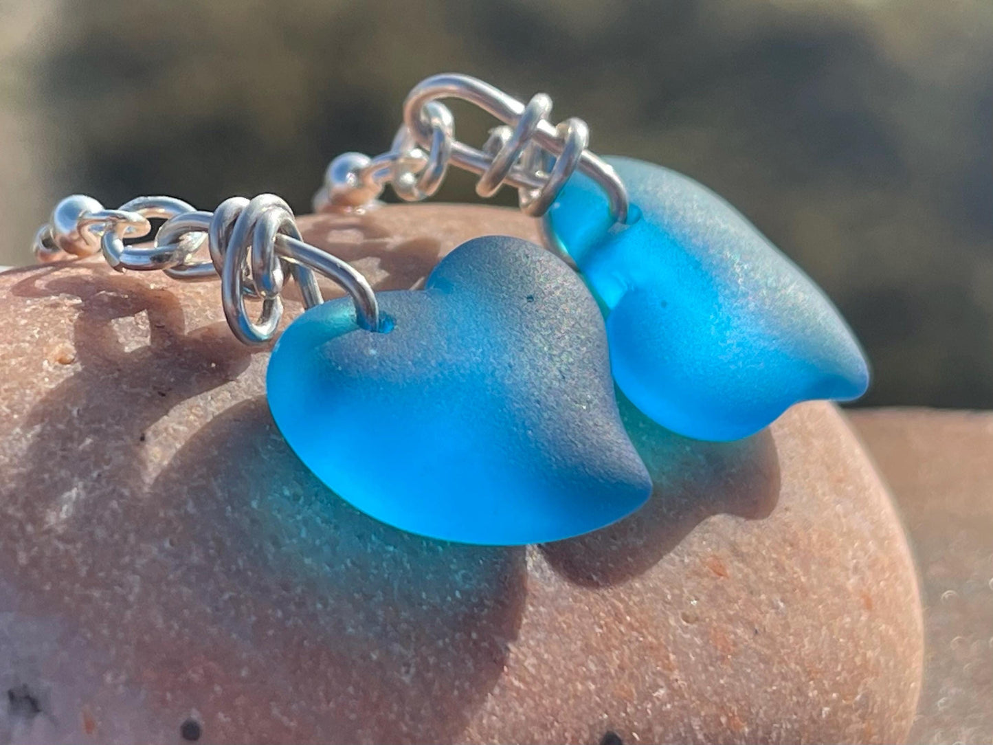 Sea glass heart earrings iron recycled sterling silver. Eco conscious jewellery. Ethical jewellery. Blue sea glass hearts. Handmade earrings