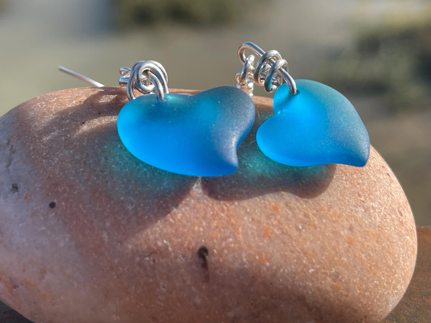Sea glass heart earrings iron recycled sterling silver. Eco conscious jewellery. Ethical jewellery. Blue sea glass hearts. Handmade earrings