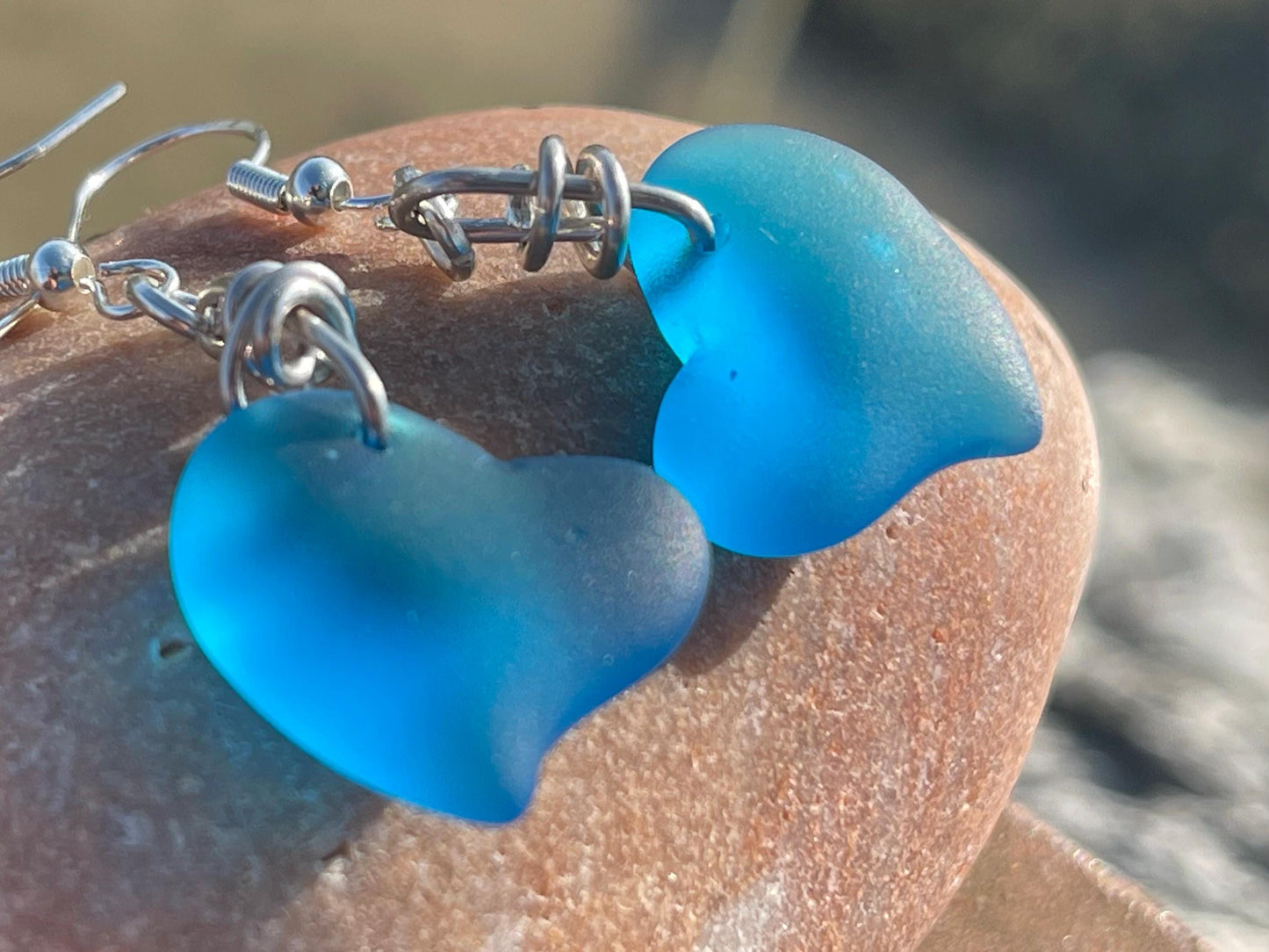 Sea glass heart earrings iron recycled sterling silver. Eco conscious jewellery. Ethical jewellery. Blue sea glass hearts. Handmade earrings