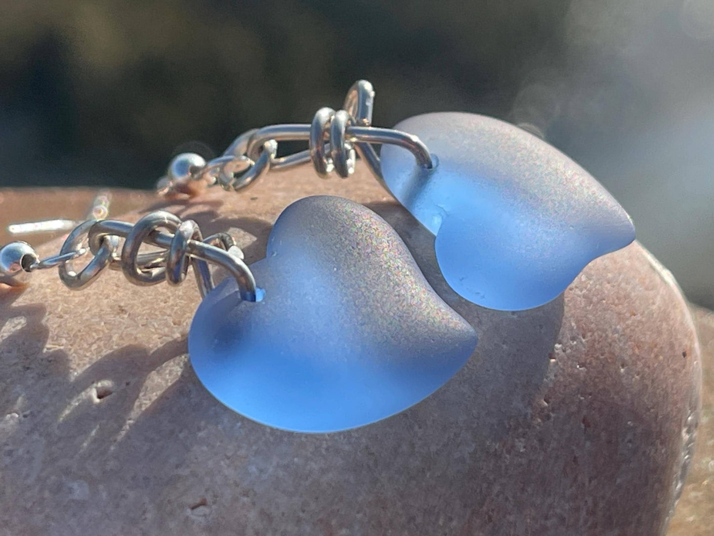 Sea glass heart earrings iron recycled sterling silver. Eco conscious jewellery. Ethical jewellery. Blue sea glass hearts. Handmade earrings