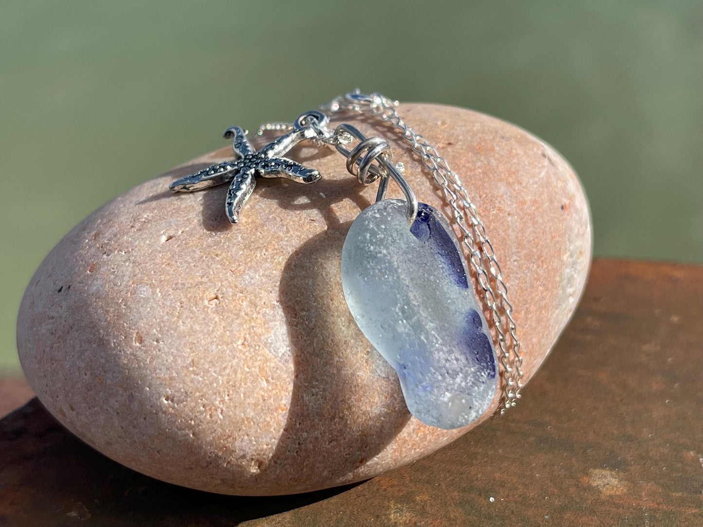 Eco friendly sea glass necklace on a sterling silver chain showcasing a starfish. Starfish pendant, starfish necklace, ethical jewellery