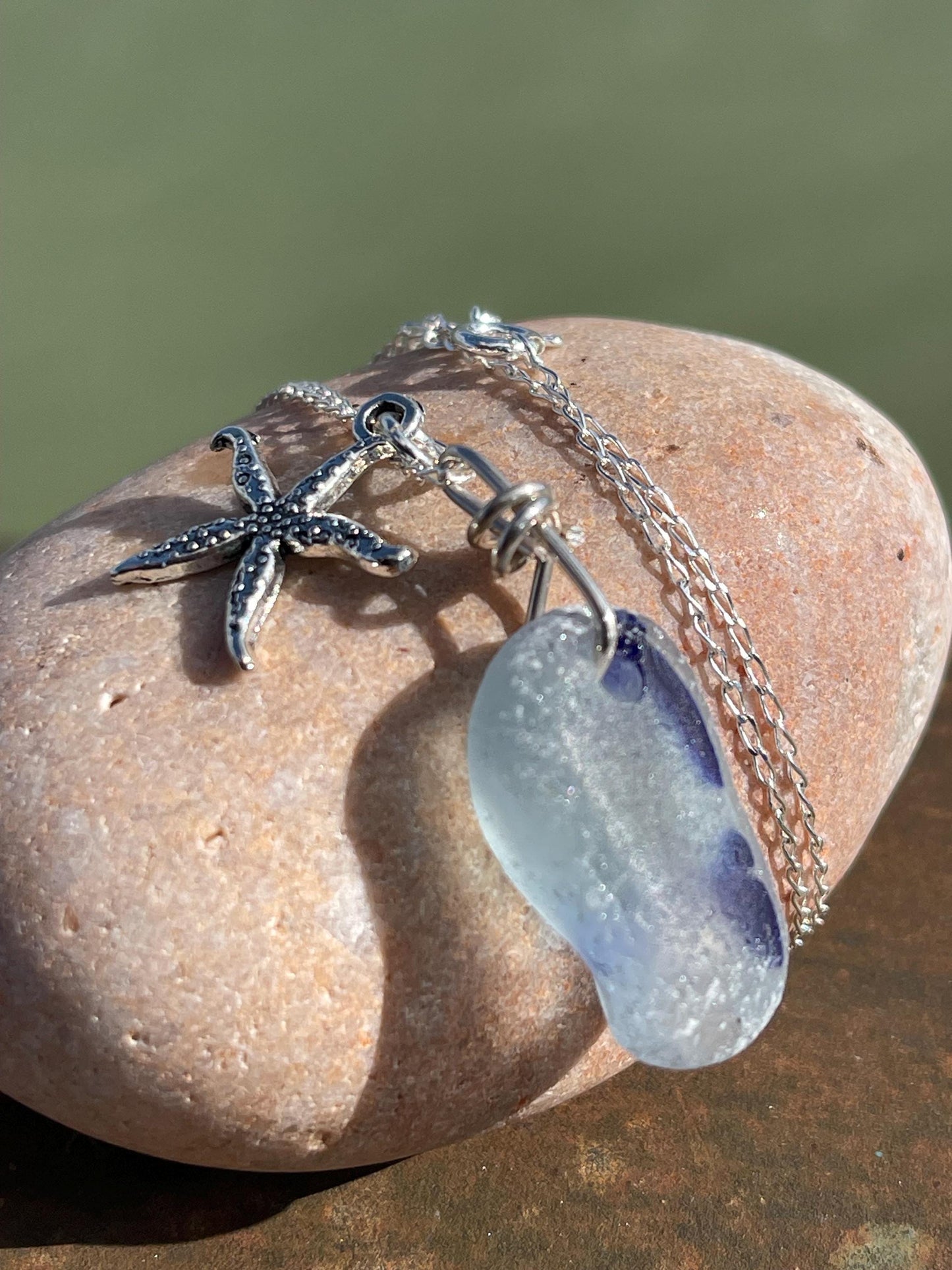 Eco friendly sea glass necklace on a sterling silver chain showcasing a starfish. Starfish pendant, starfish necklace, ethical jewellery