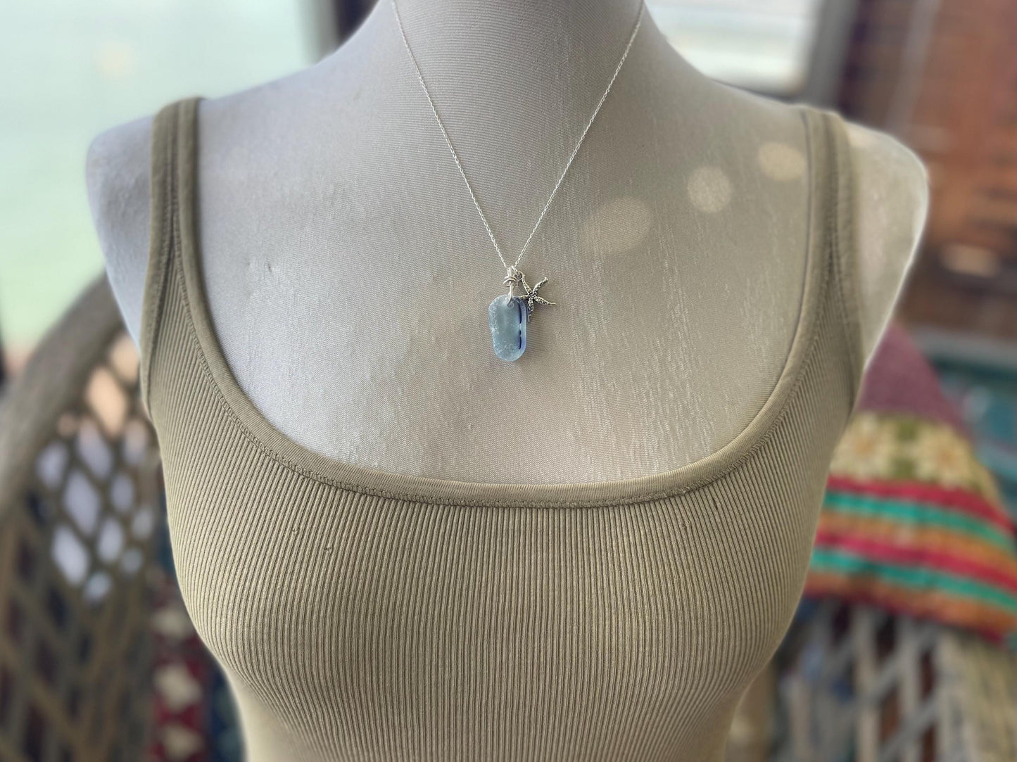 Eco friendly sea glass necklace on a sterling silver chain showcasing a starfish. Starfish pendant, starfish necklace, ethical jewellery
