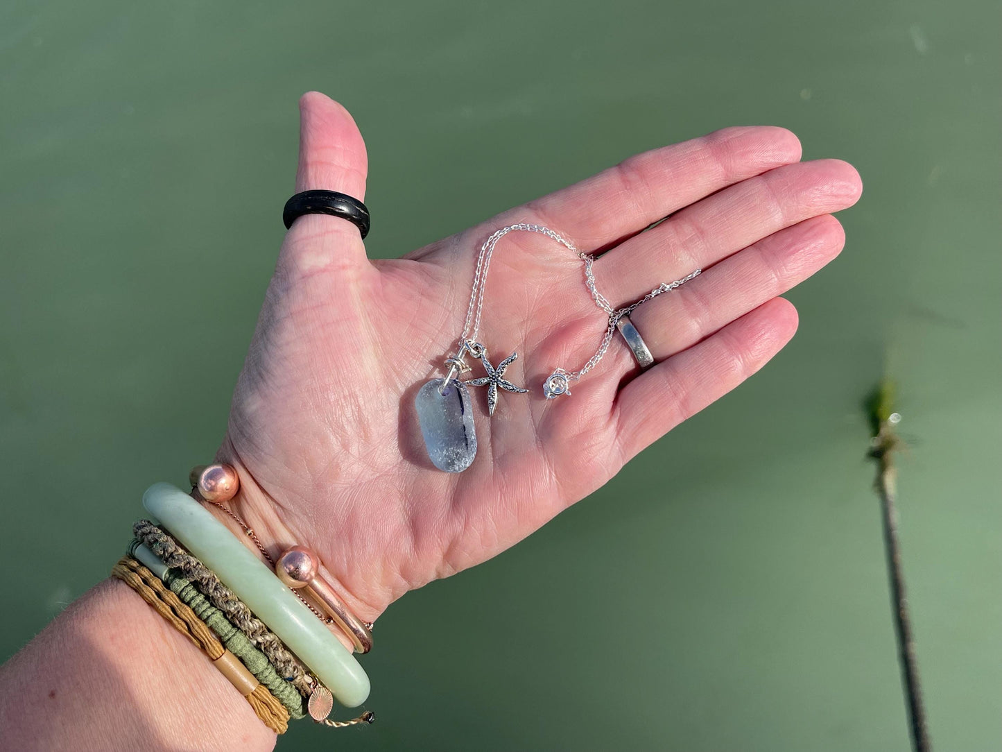 Eco friendly sea glass necklace on a sterling silver chain showcasing a starfish. Starfish pendant, starfish necklace, ethical jewellery