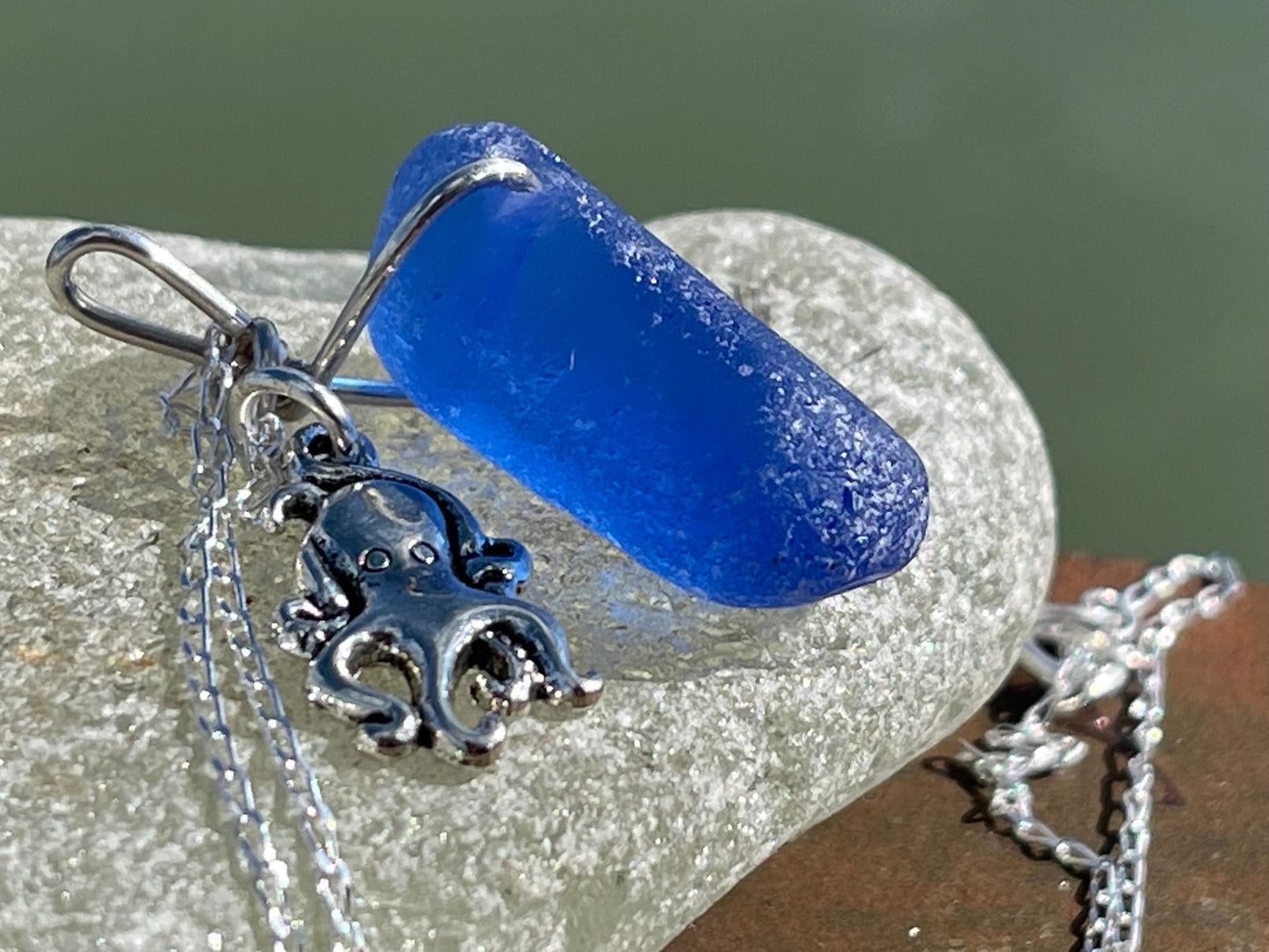 Eco friendly sea glass necklace on a sterling silver chain showcasing a little octopus. Octopus pendant, octopus necklace, ethical jewellery