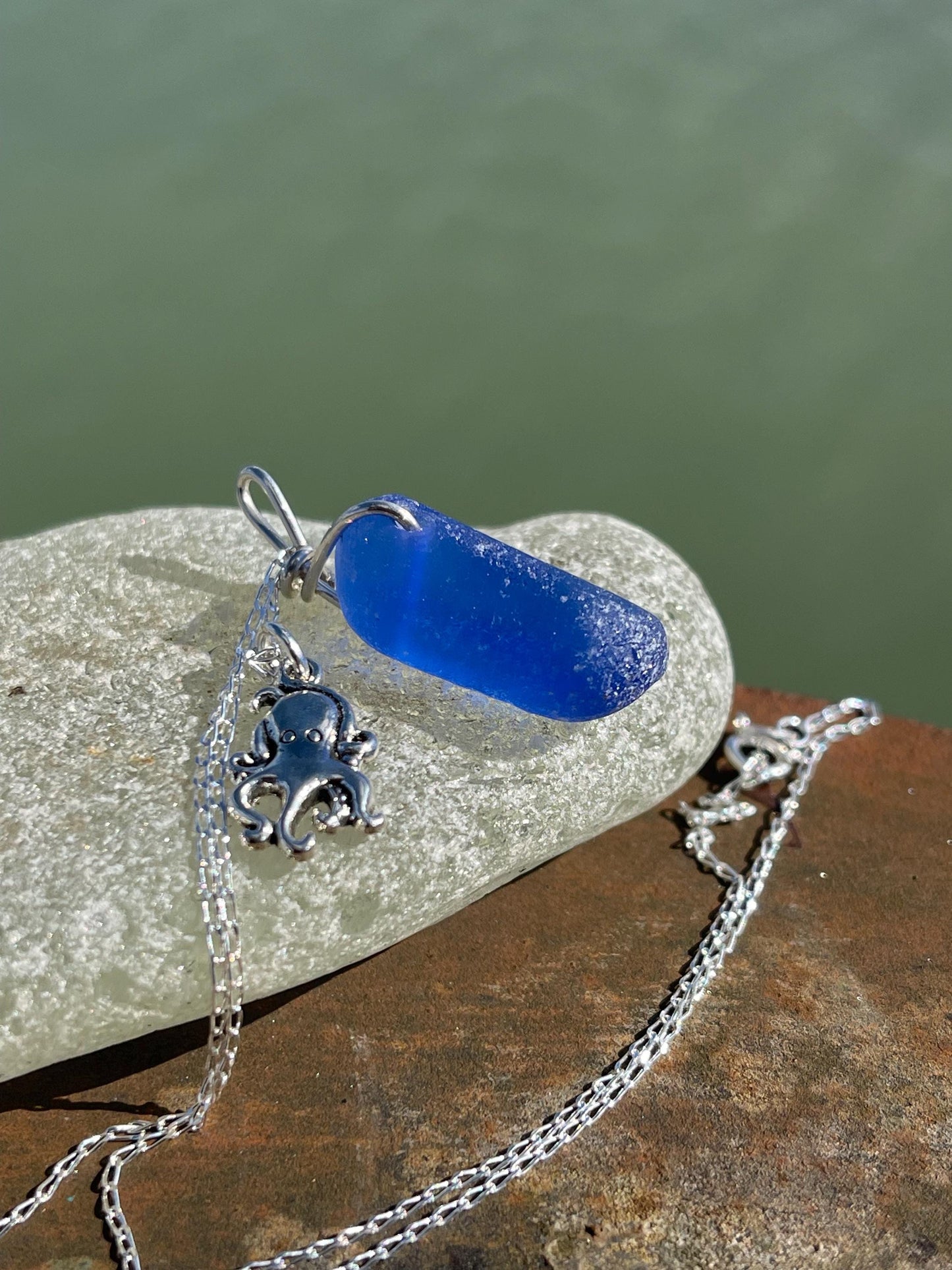 Eco friendly sea glass necklace on a sterling silver chain showcasing a little octopus. Octopus pendant, octopus necklace, ethical jewellery