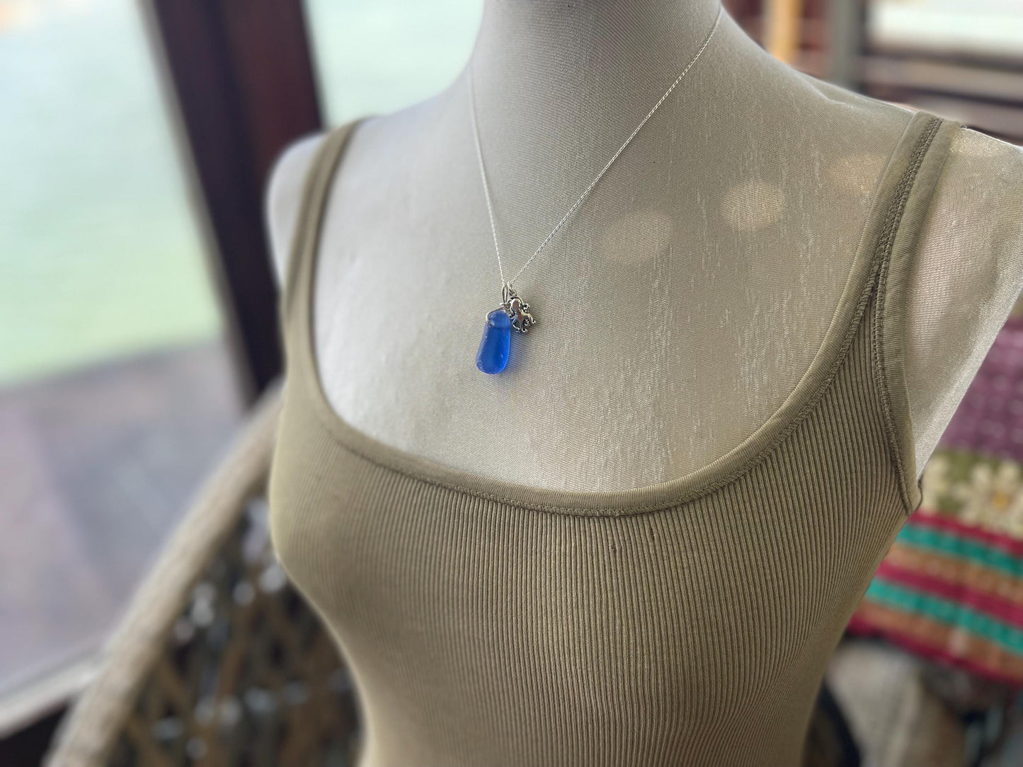 Eco friendly sea glass necklace on a sterling silver chain showcasing a little octopus. Octopus pendant, octopus necklace, ethical jewellery