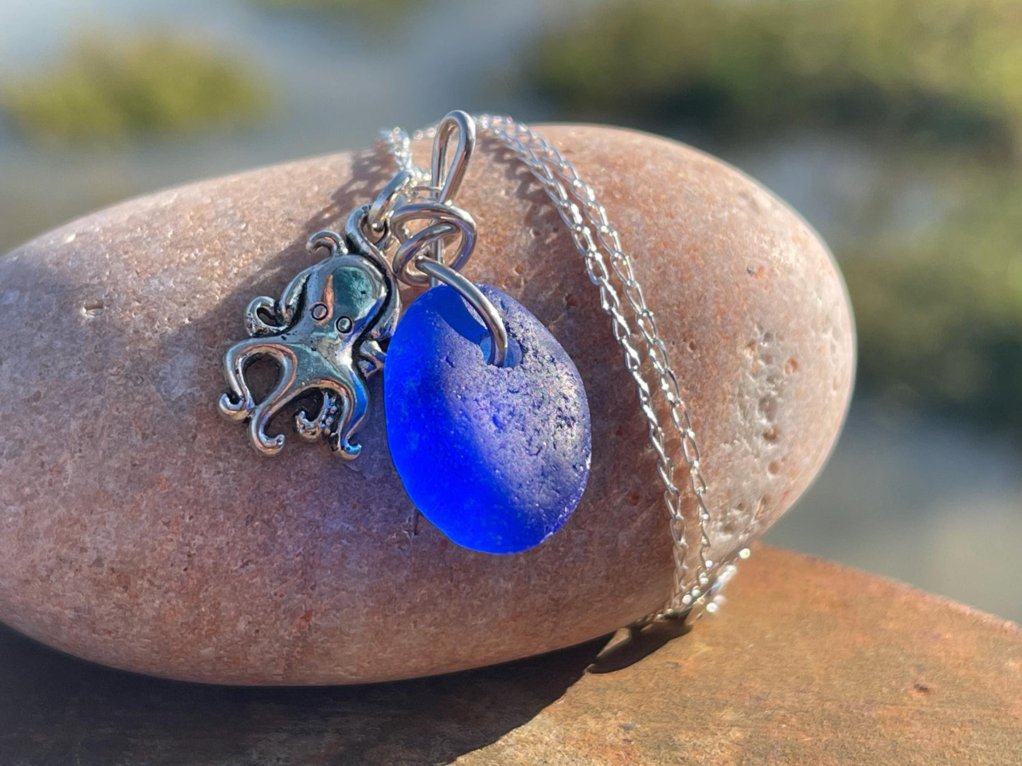 Eco friendly sea glass necklace on a sterling silver chain showcasing a little octopus. Octopus pendant, octopus necklace, ethical jewellery