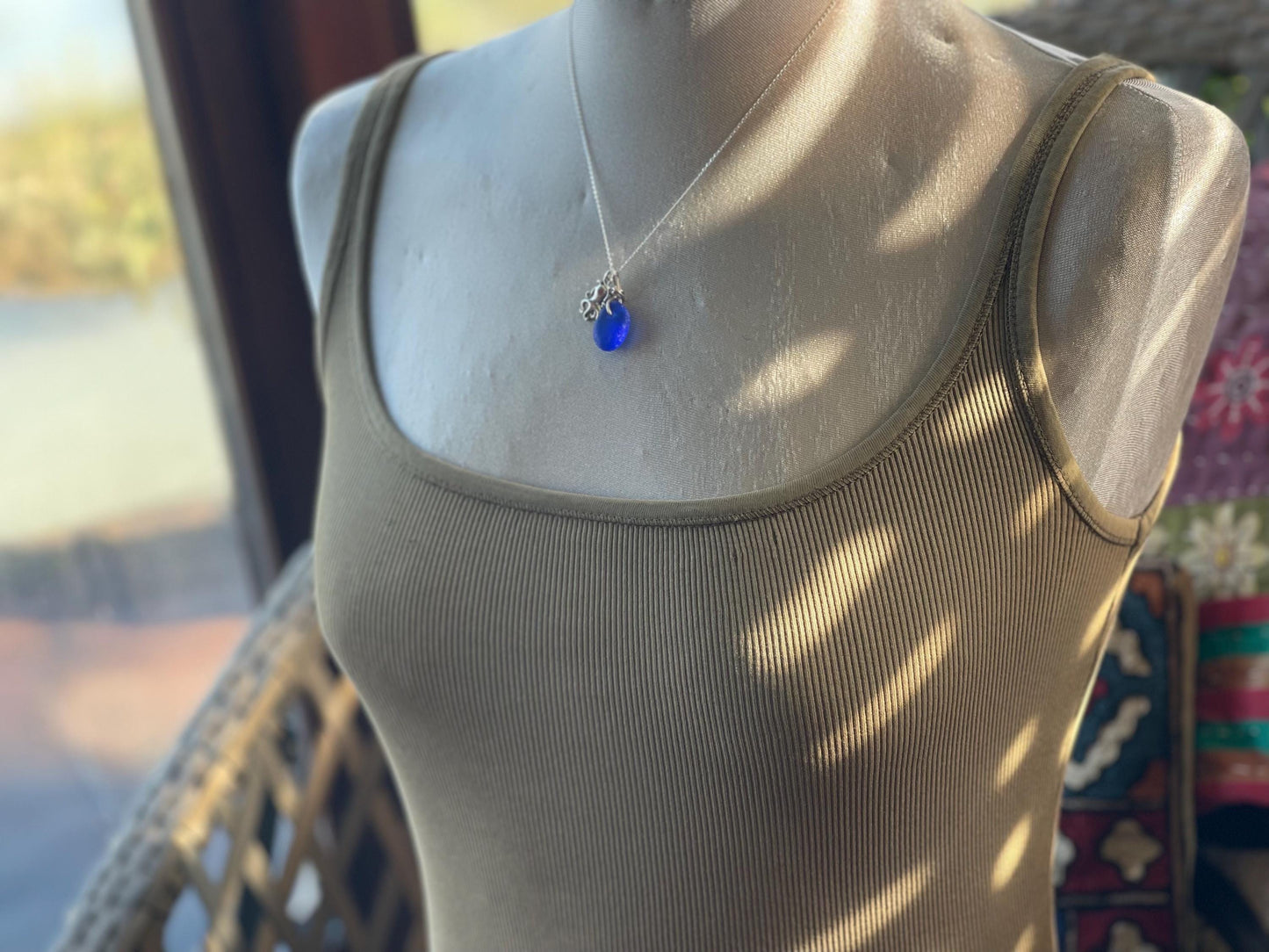 Eco friendly sea glass necklace on a sterling silver chain showcasing a little octopus. Octopus pendant, octopus necklace, ethical jewellery