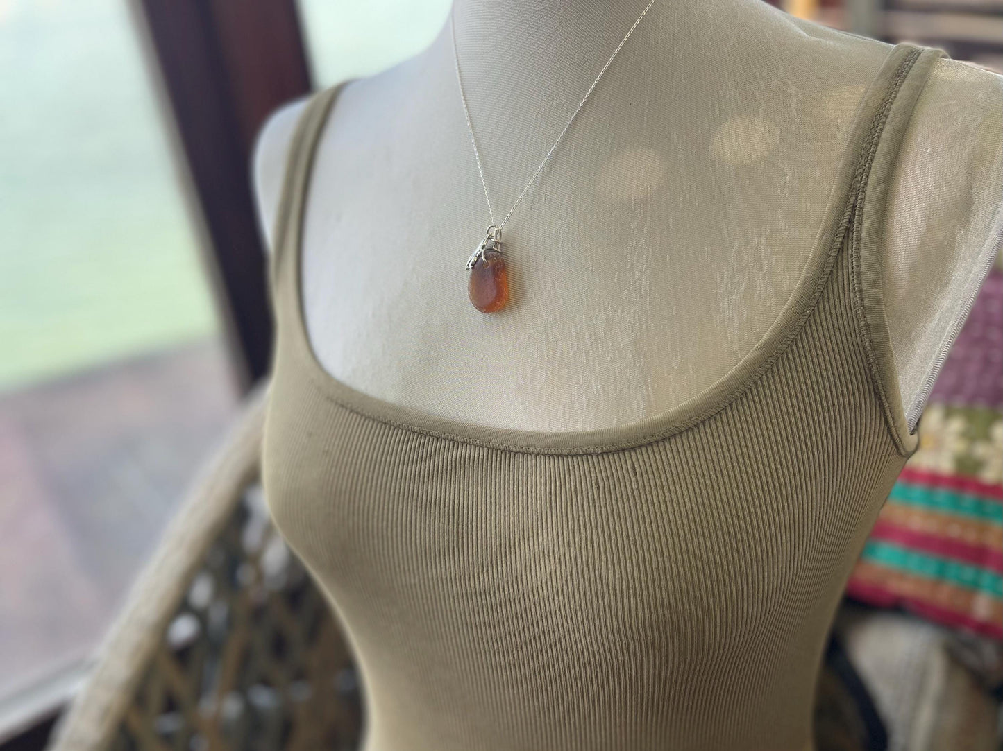 Eco friendly sea glass necklace on a sterling silver chain showcasing a little octopus. Octopus pendant, octopus necklace, ethical jewellery