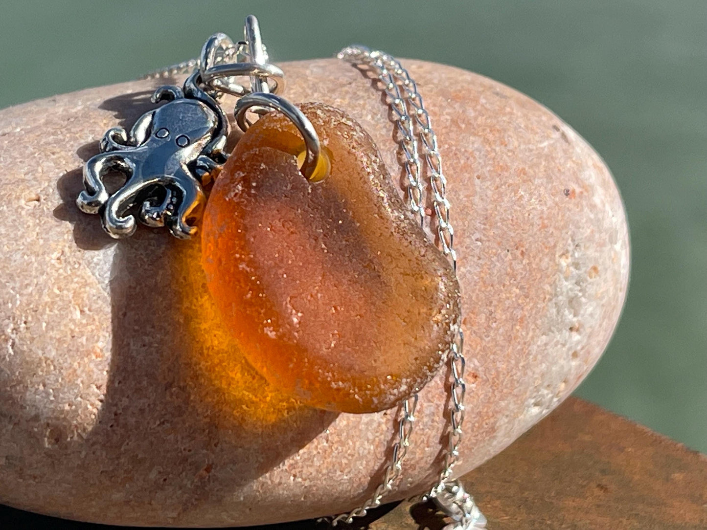 Eco friendly sea glass necklace on a sterling silver chain showcasing a little octopus. Octopus pendant, octopus necklace, ethical jewellery