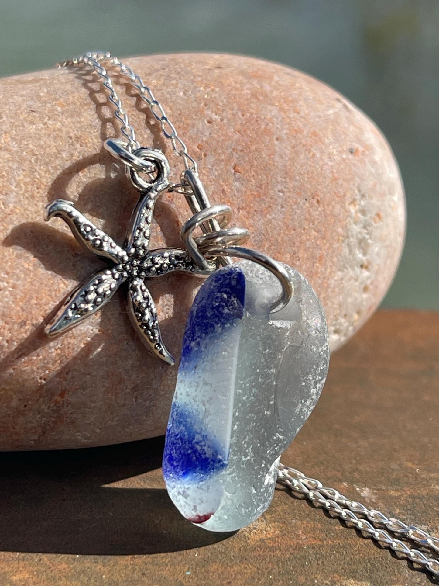 Eco friendly sea glass necklace on a sterling silver chain showcasing a starfish. Starfish pendant, starfish necklace, ethical jewellery
