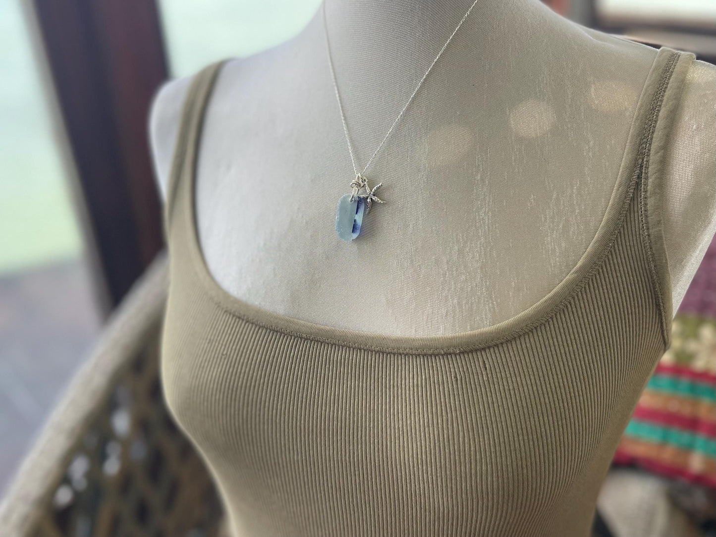 Eco friendly sea glass necklace on a sterling silver chain showcasing a starfish. Starfish pendant, starfish necklace, ethical jewellery