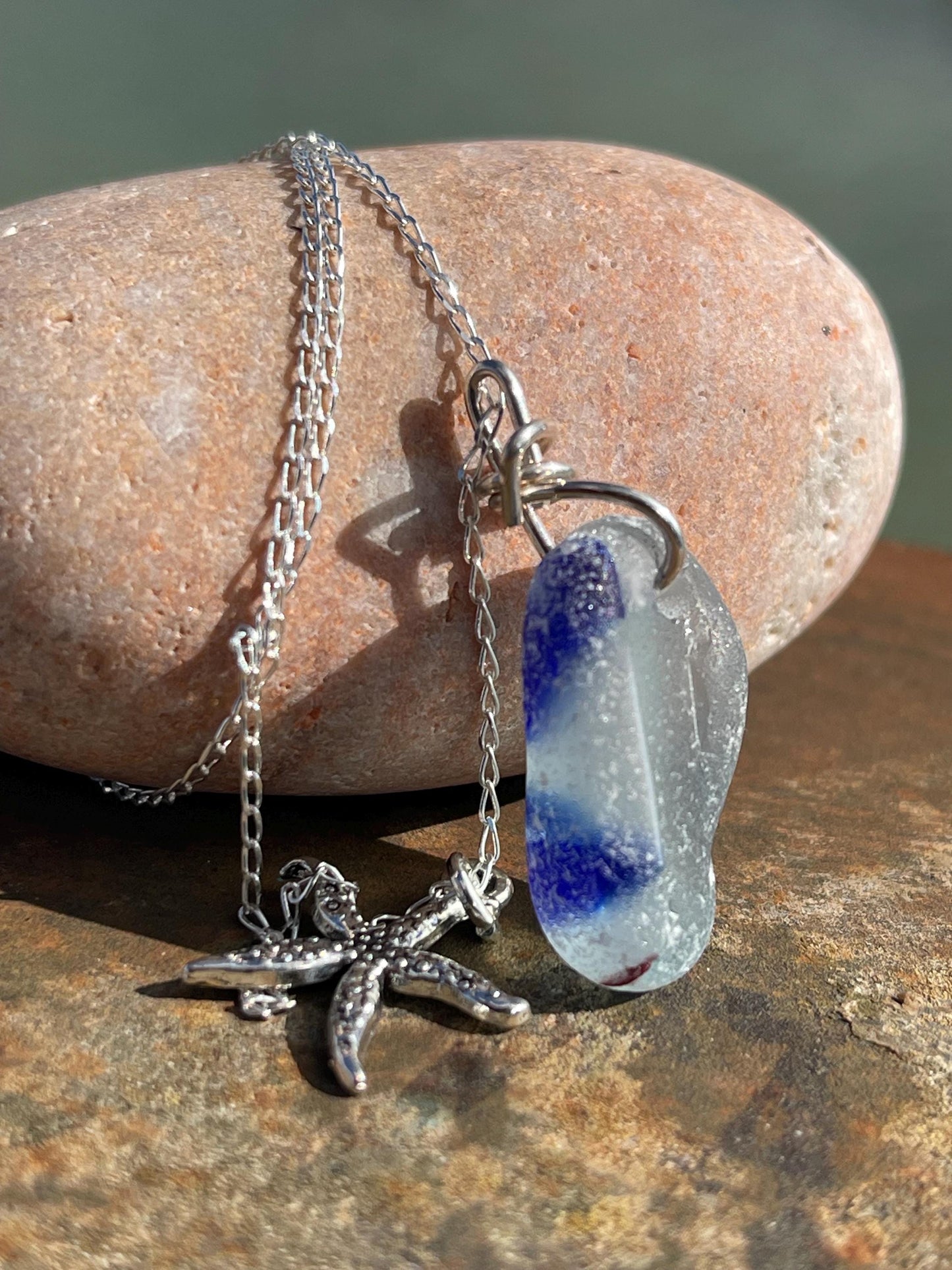 Eco friendly sea glass necklace on a sterling silver chain showcasing a starfish. Starfish pendant, starfish necklace, ethical jewellery