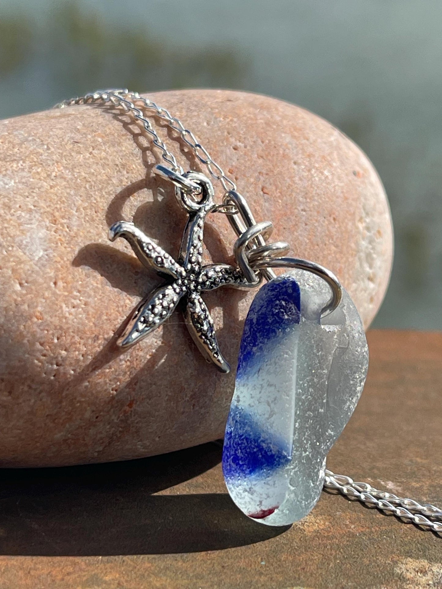 Eco friendly sea glass necklace on a sterling silver chain showcasing a starfish. Starfish pendant, starfish necklace, ethical jewellery