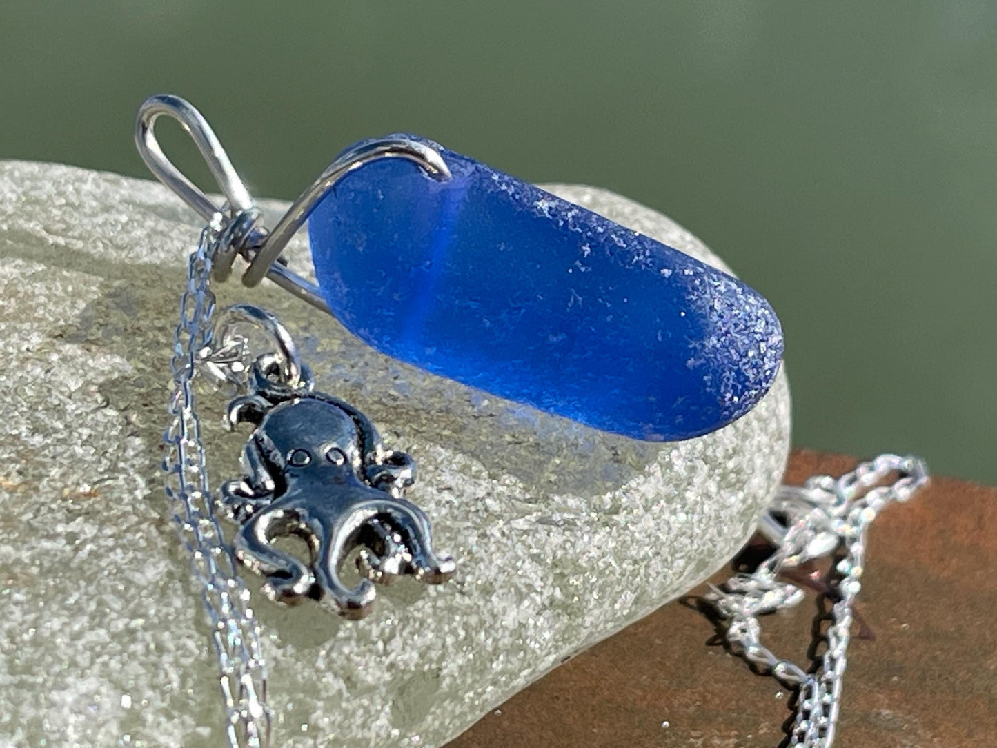 Eco friendly sea glass necklace on a sterling silver chain showcasing a little octopus. Octopus pendant, octopus necklace, ethical jewellery