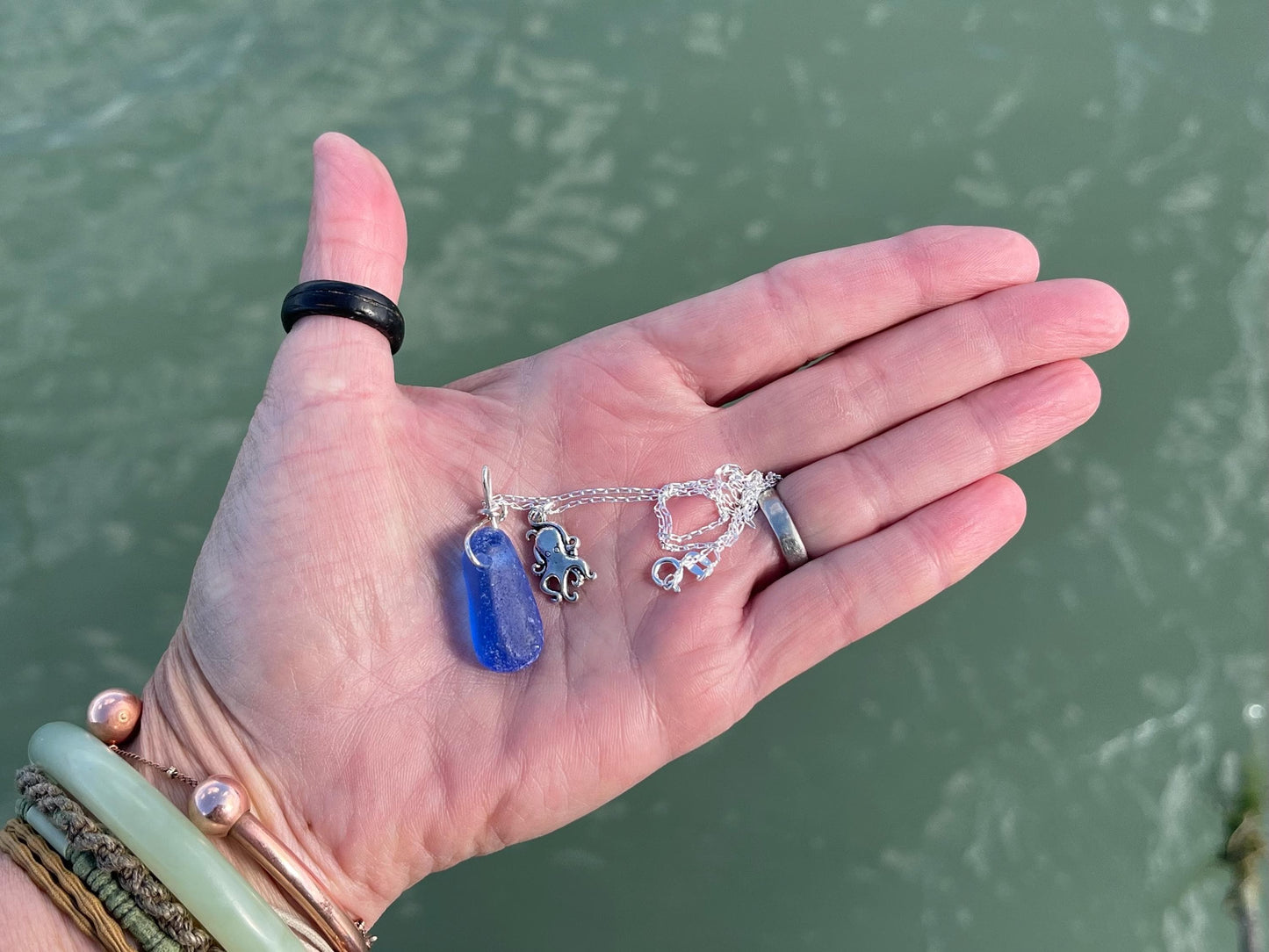 Eco friendly sea glass necklace on a sterling silver chain showcasing a little octopus. Octopus pendant, octopus necklace, ethical jewellery