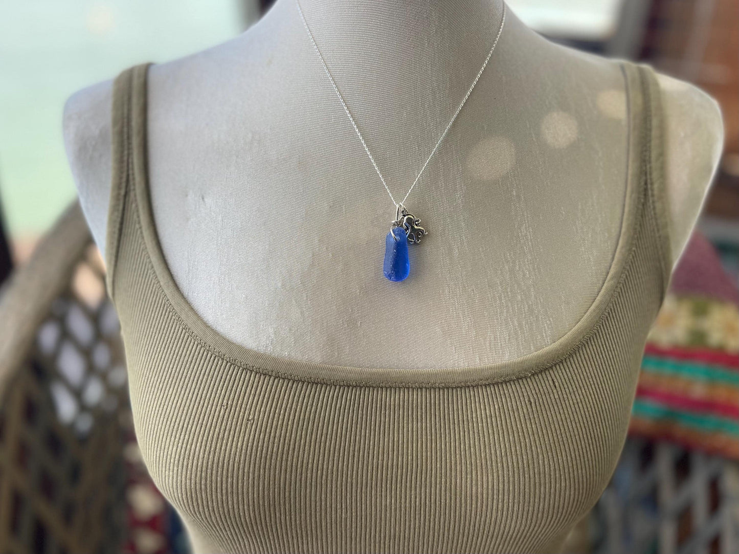 Eco friendly sea glass necklace on a sterling silver chain showcasing a little octopus. Octopus pendant, octopus necklace, ethical jewellery
