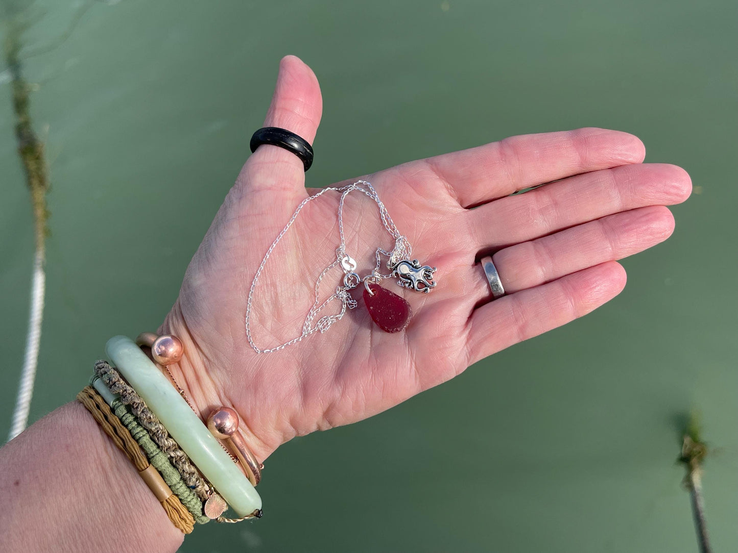 Eco friendly sea glass necklace on a sterling silver chain showcasing a little octopus. Octopus pendant, octopus necklace, ethical jewellery