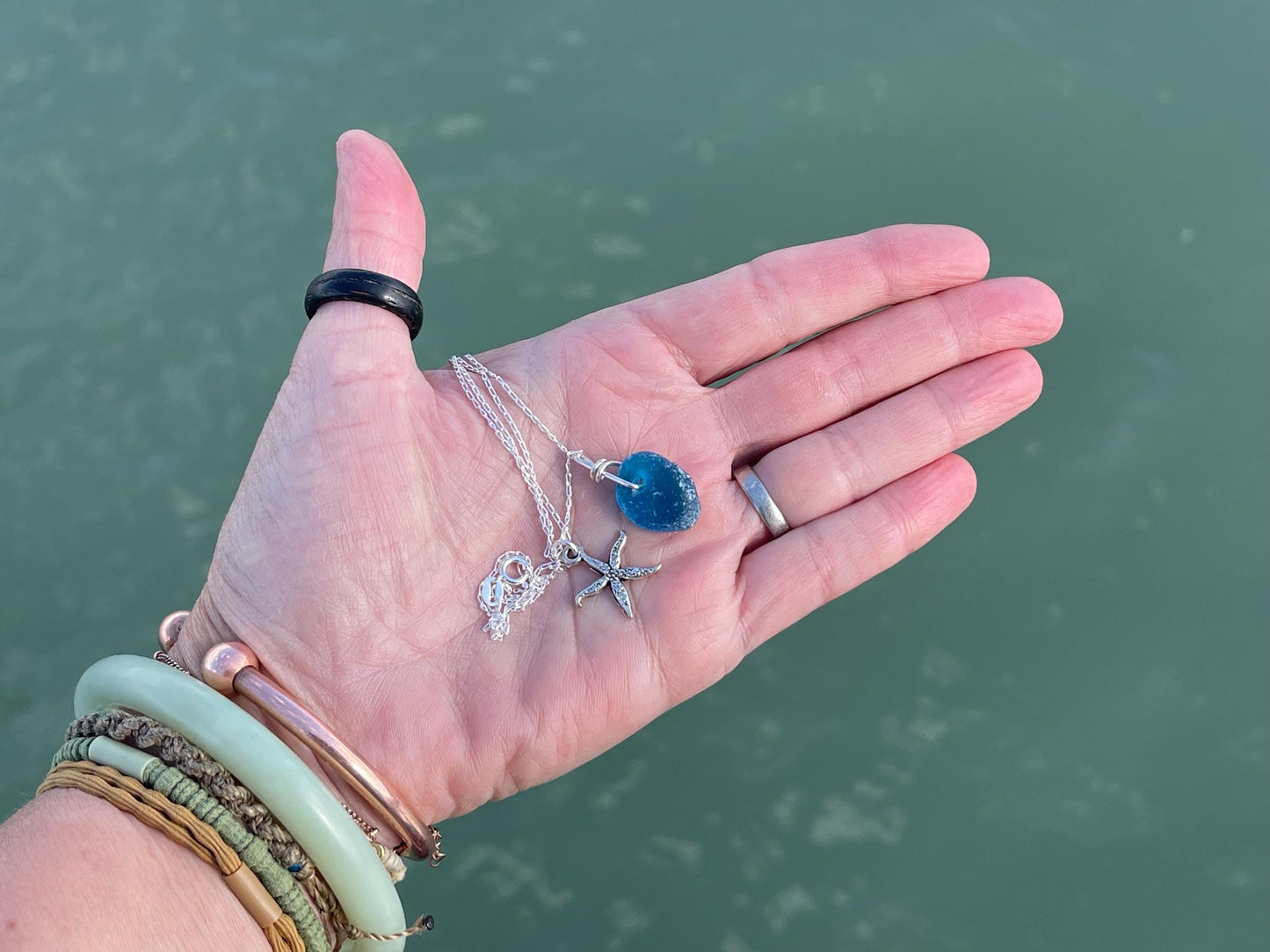Eco friendly sea glass necklace on a sterling silver chain showcasing a little starfish. Starfish pendant, ethical jewellery. Sea swimming
