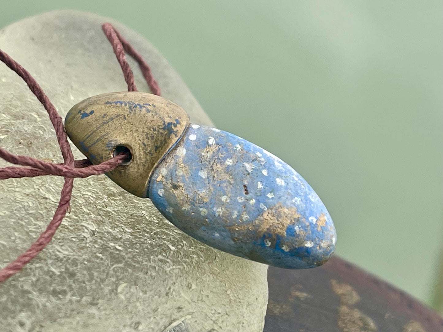 Pebble pendants. Painted pebble necklaces. Hand painted eco friendly necklaces. Eco friendly jewellery. Ethical handmade jewellery.