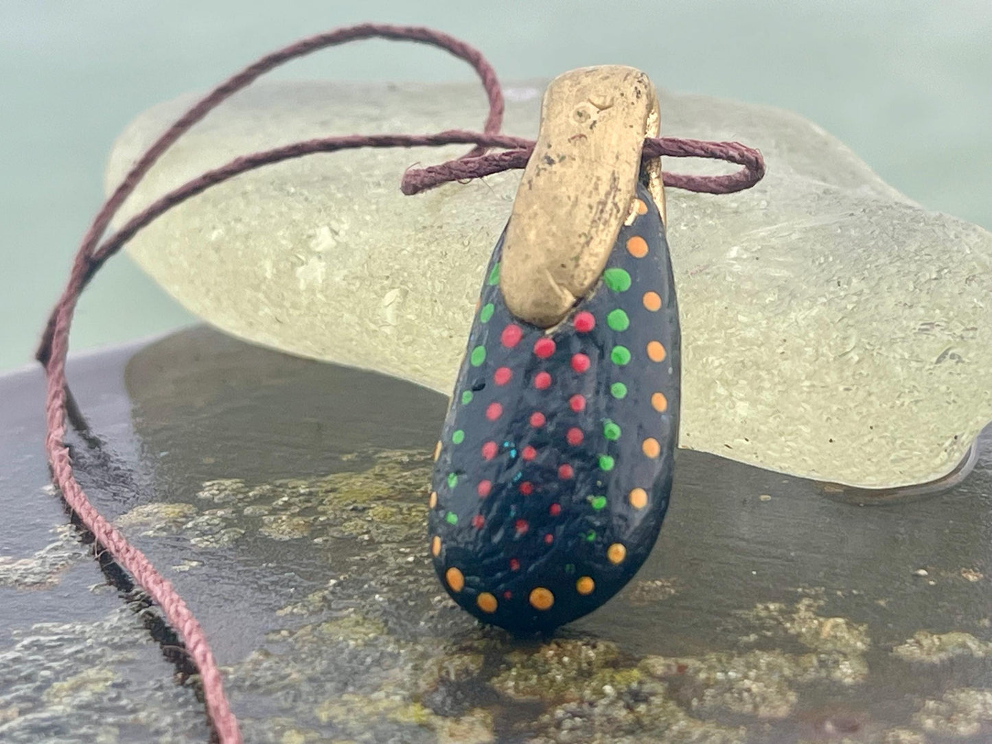 Pebble pendants. Painted pebble necklaces. Hand painted eco friendly necklaces. Eco friendly jewellery. Ethical handmade jewellery.