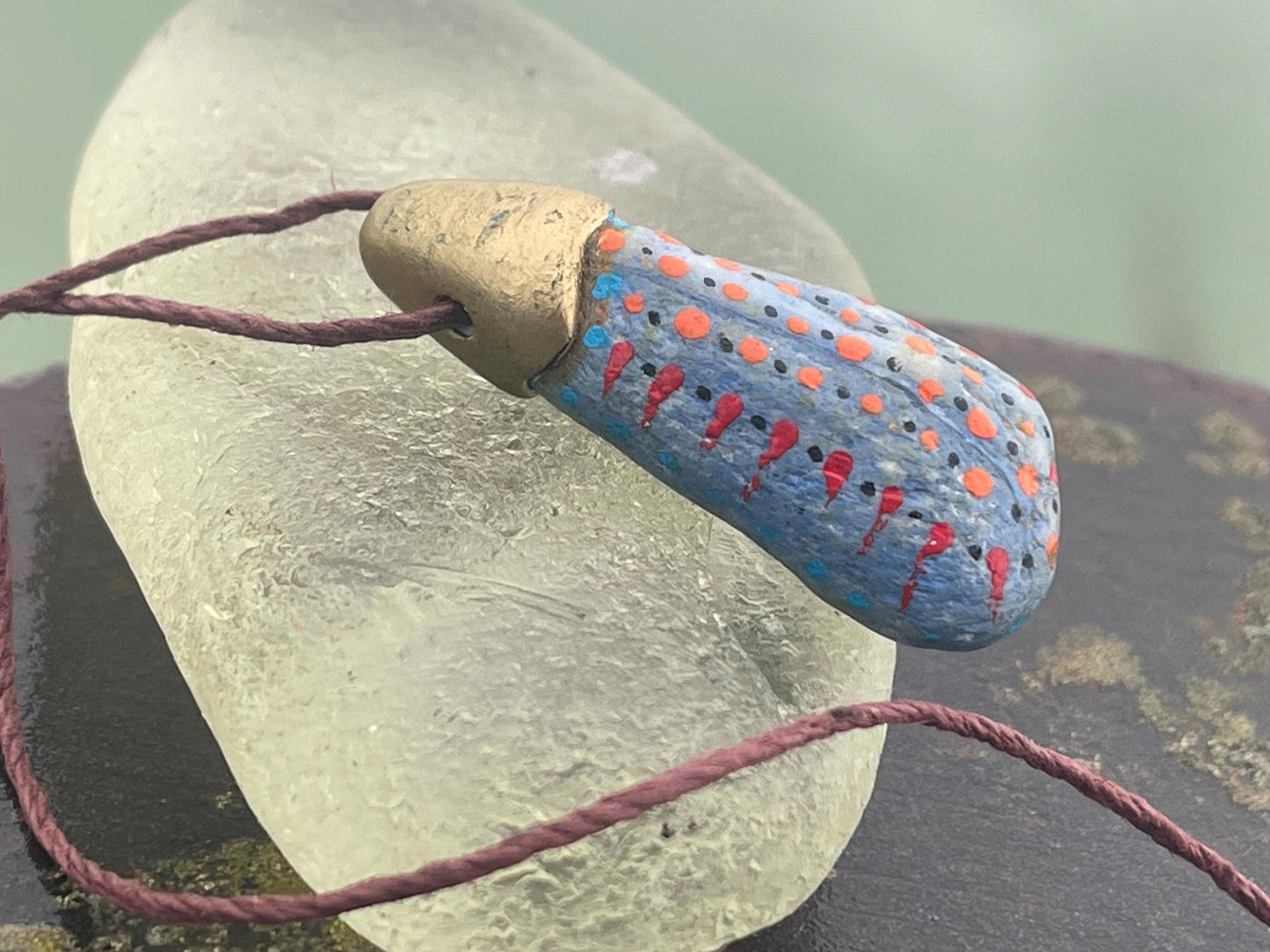 Pebble pendants. Painted pebble necklaces. Hand painted eco friendly necklaces. Eco friendly jewellery. Ethical handmade jewellery.