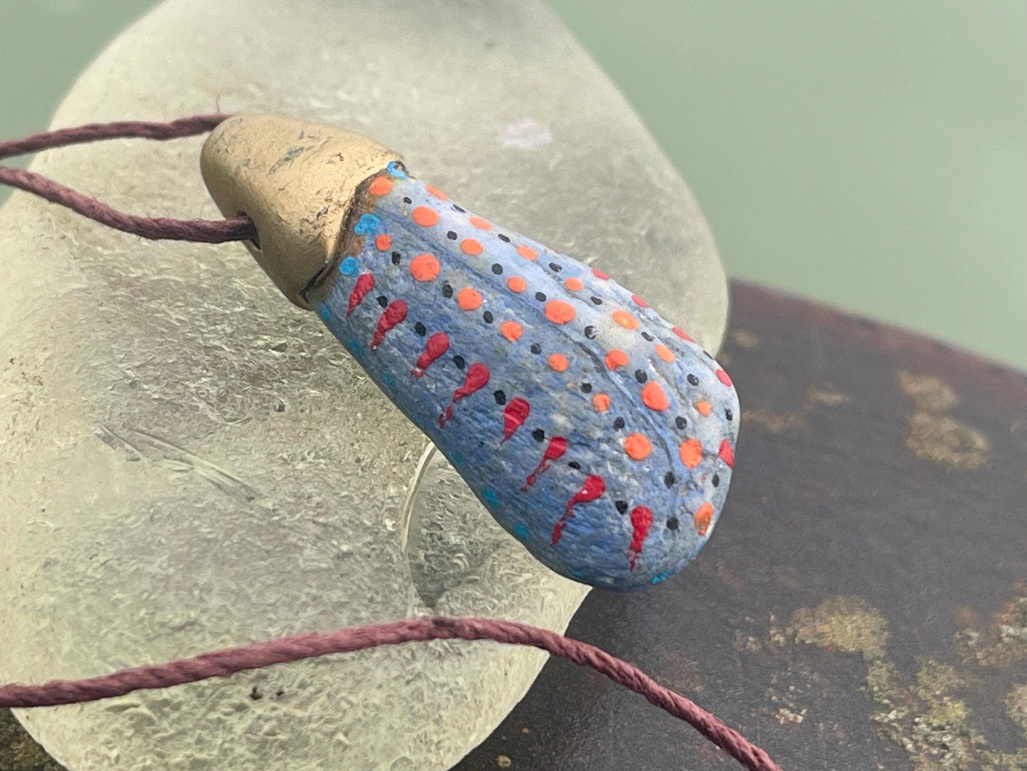 Pebble pendants. Painted pebble necklaces. Hand painted eco friendly necklaces. Eco friendly jewellery. Ethical handmade jewellery.