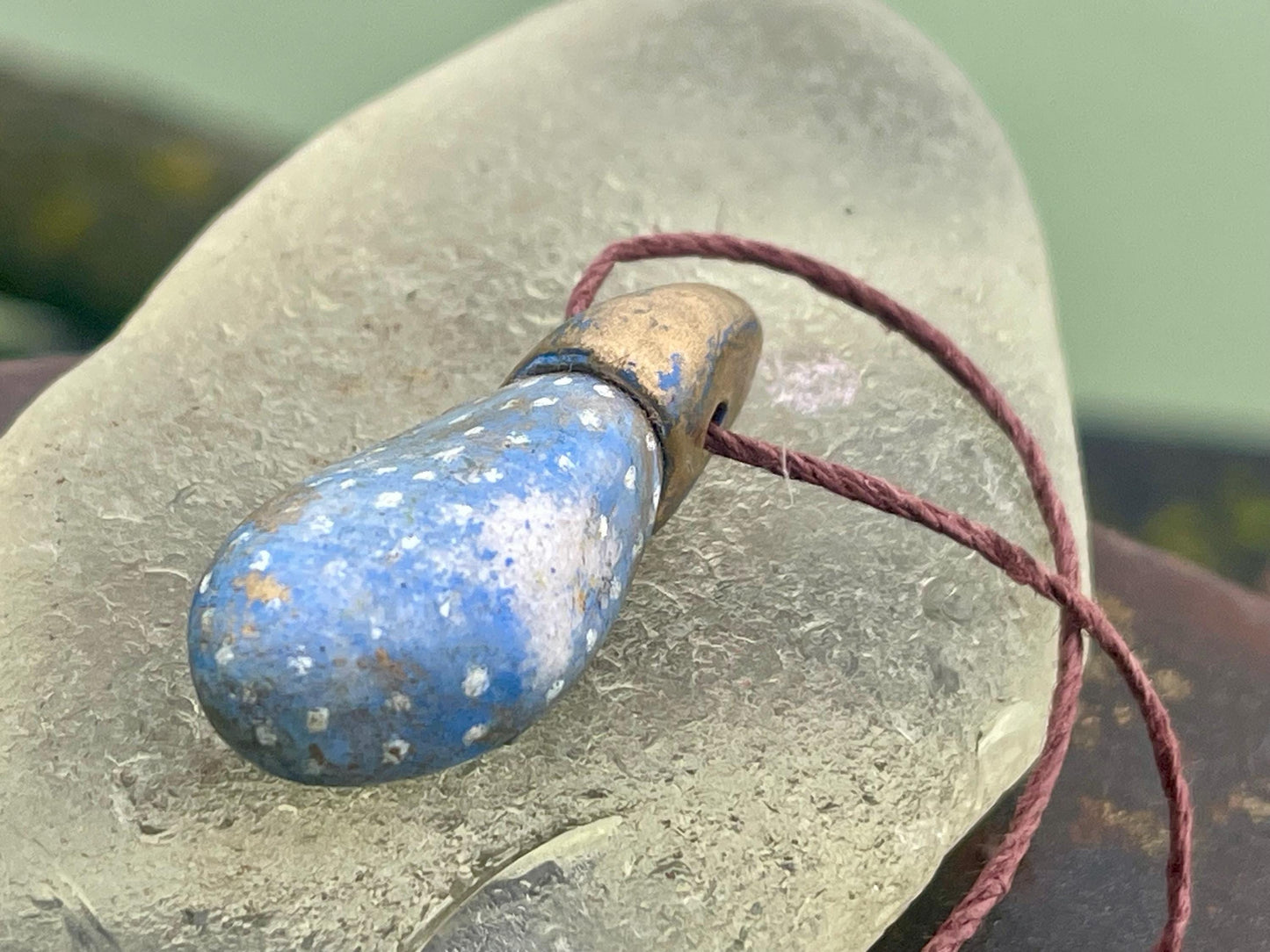 Pebble pendants. Painted pebble necklaces. Hand painted eco friendly necklaces. Eco friendly jewellery. Ethical handmade jewellery.