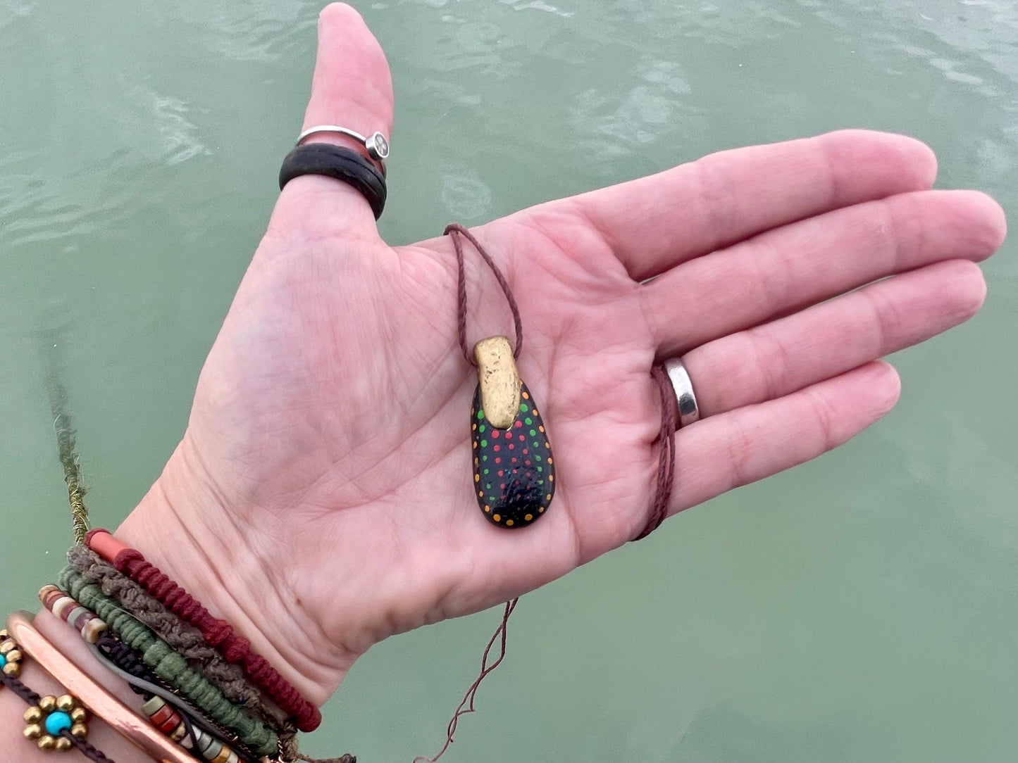 Pebble pendants. Painted pebble necklaces. Hand painted eco friendly necklaces. Eco friendly jewellery. Ethical handmade jewellery.