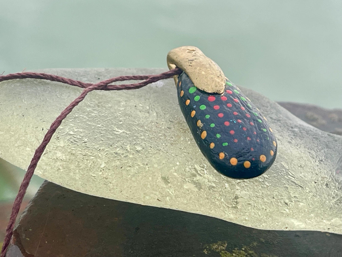 Pebble pendants. Painted pebble necklaces. Hand painted eco friendly necklaces. Eco friendly jewellery. Ethical handmade jewellery.